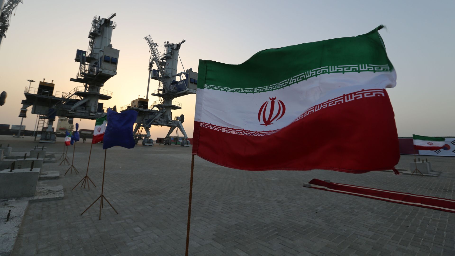 In this image, the Iranian flag flies in an oil field.