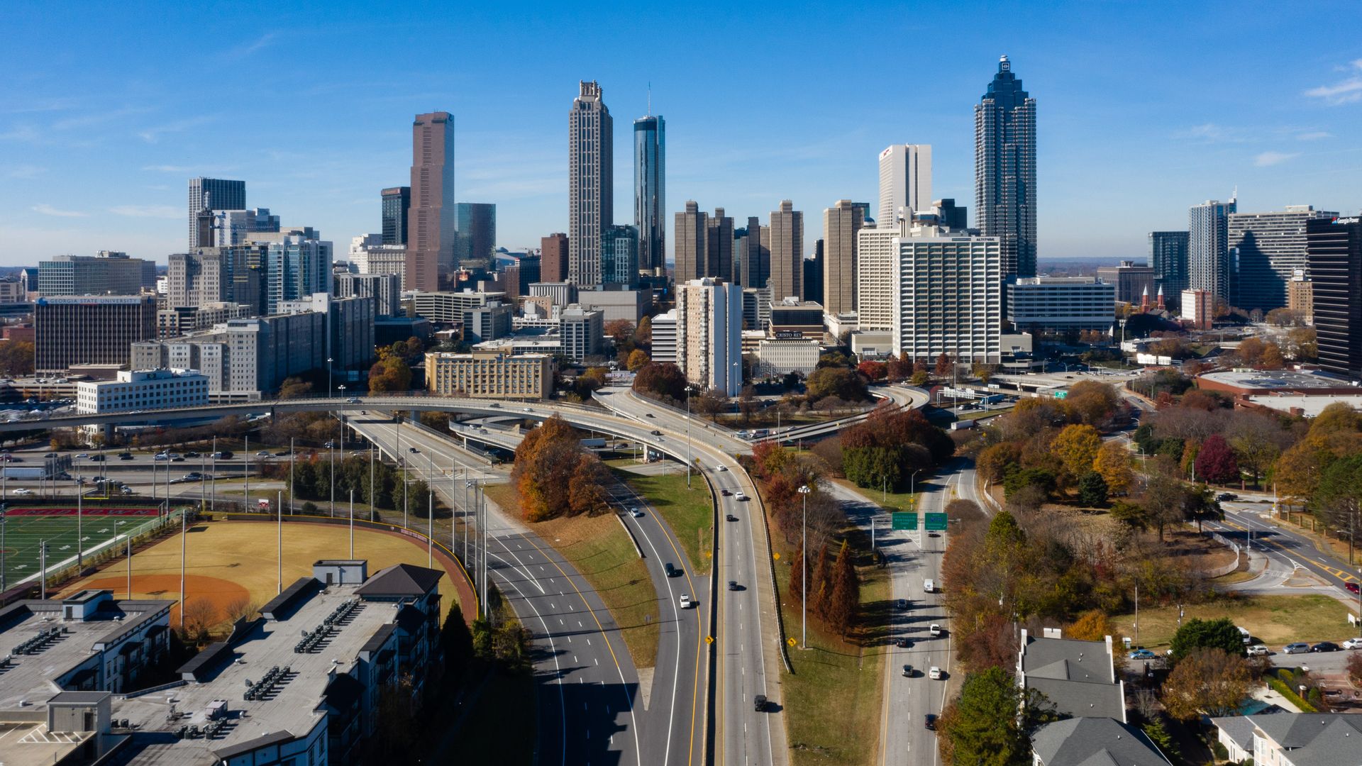 A photo of the Atlanta downtown skyline with an interstate on-ramp in the foreground