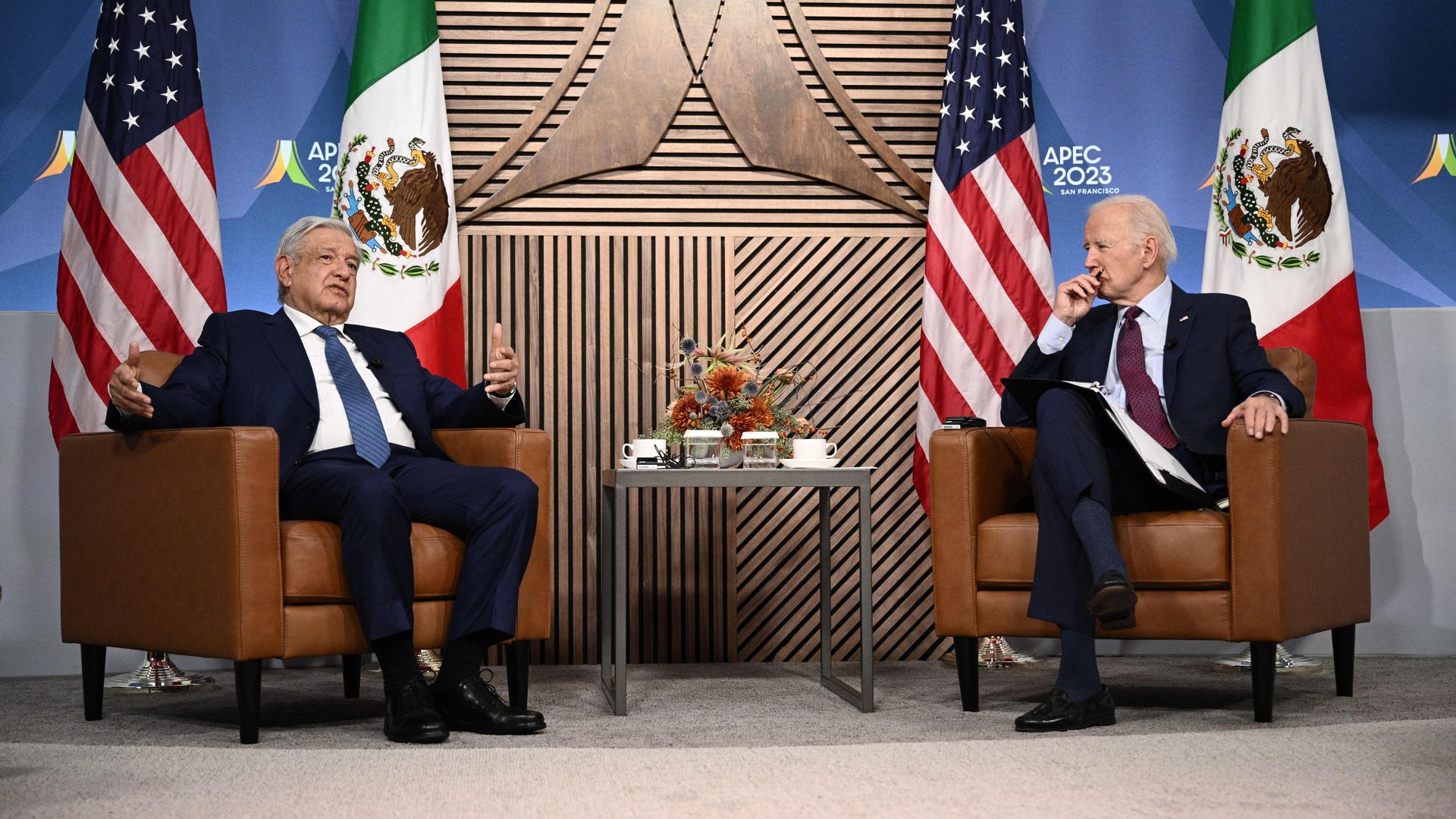 Joe Biden (R) looks on as Mexican President Andres Manuel Lopez Obrador speaks during a bilateral meeting 