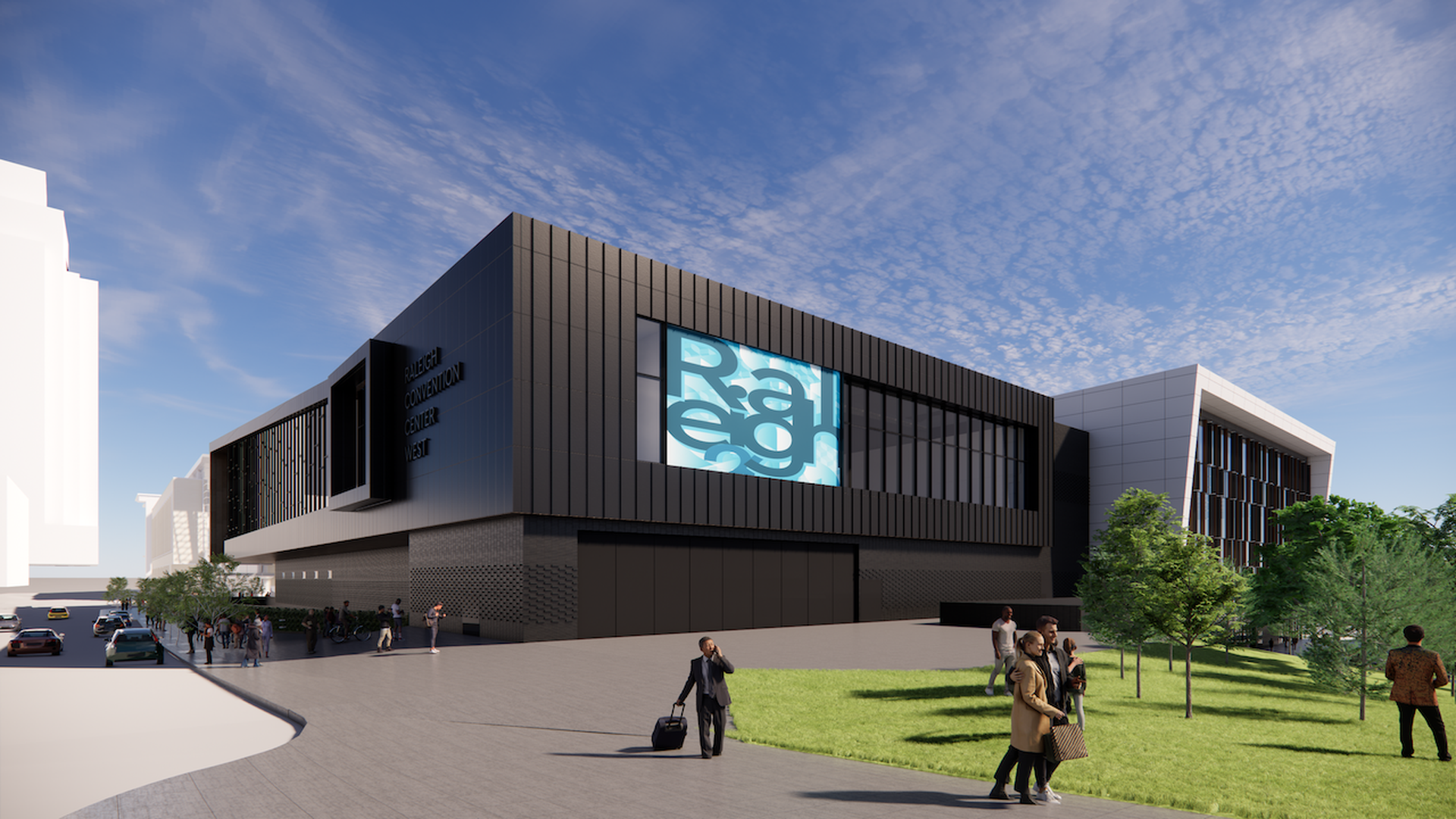 Modern black and gray Raleigh Convention Center West building with large digital screen, people walking nearby, green grass, trees, and blue sky with scattered clouds.