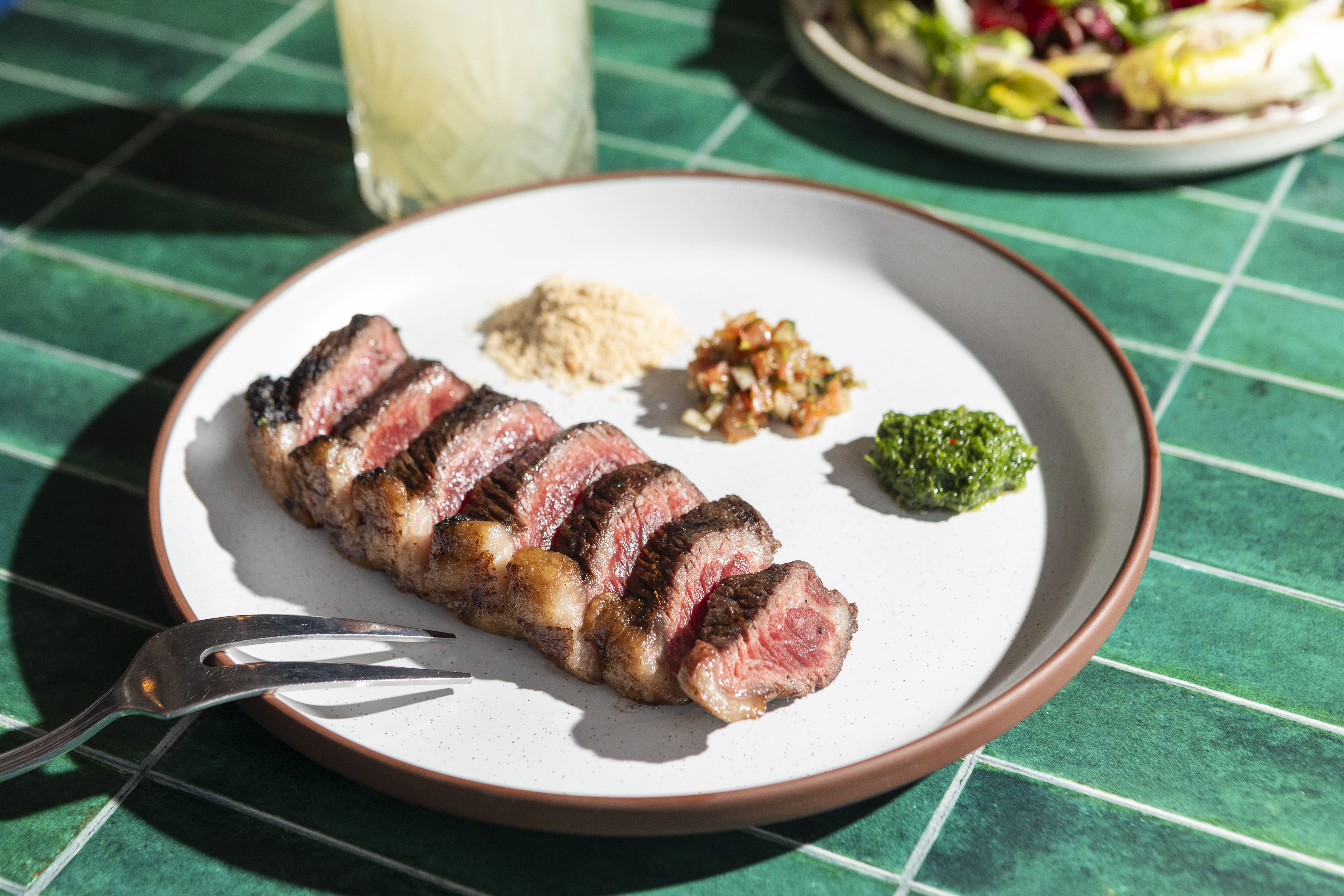 Photo of steak pieces lined up on a plate 