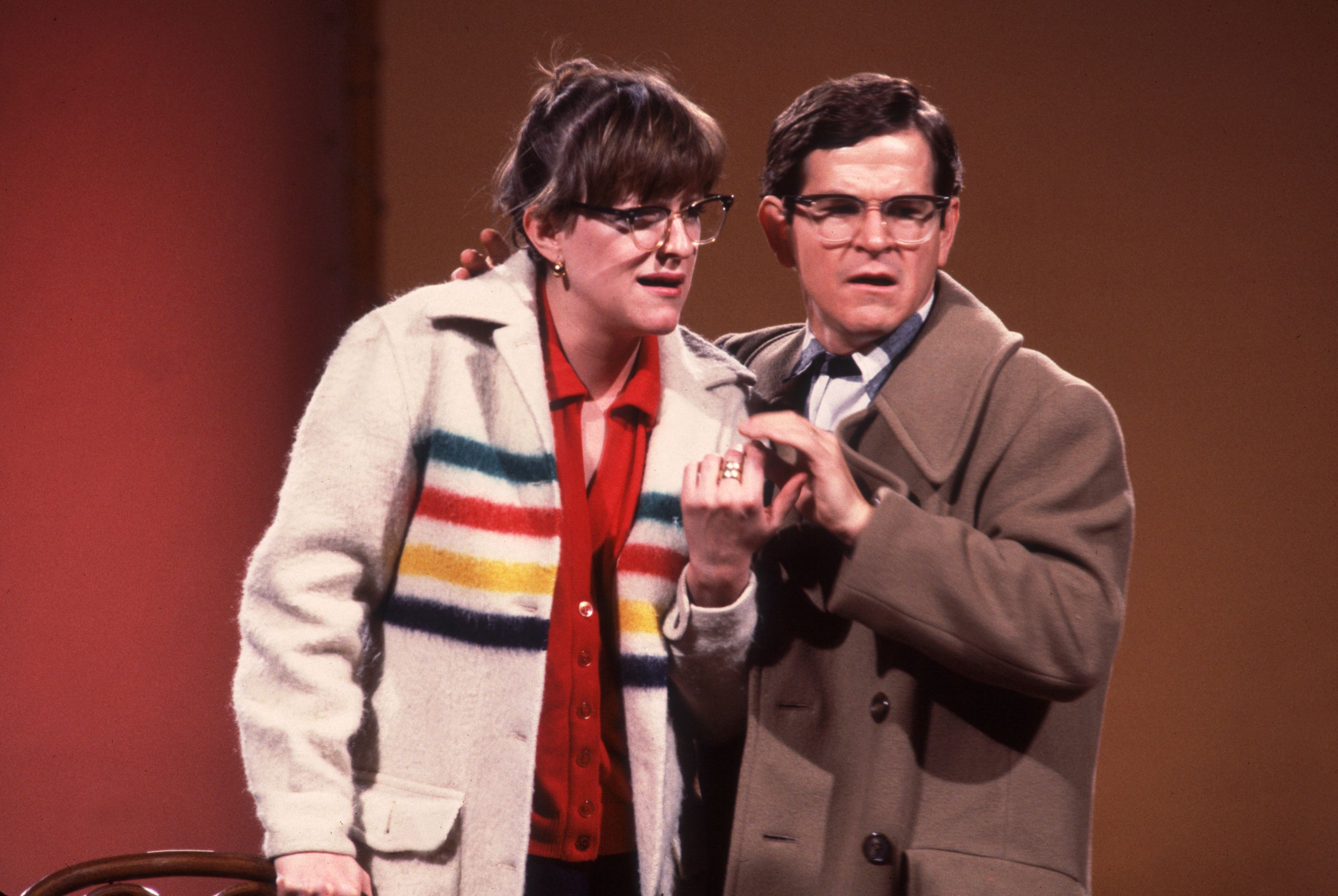 Photo of two actors on a stage doing a theatrical scene in a play