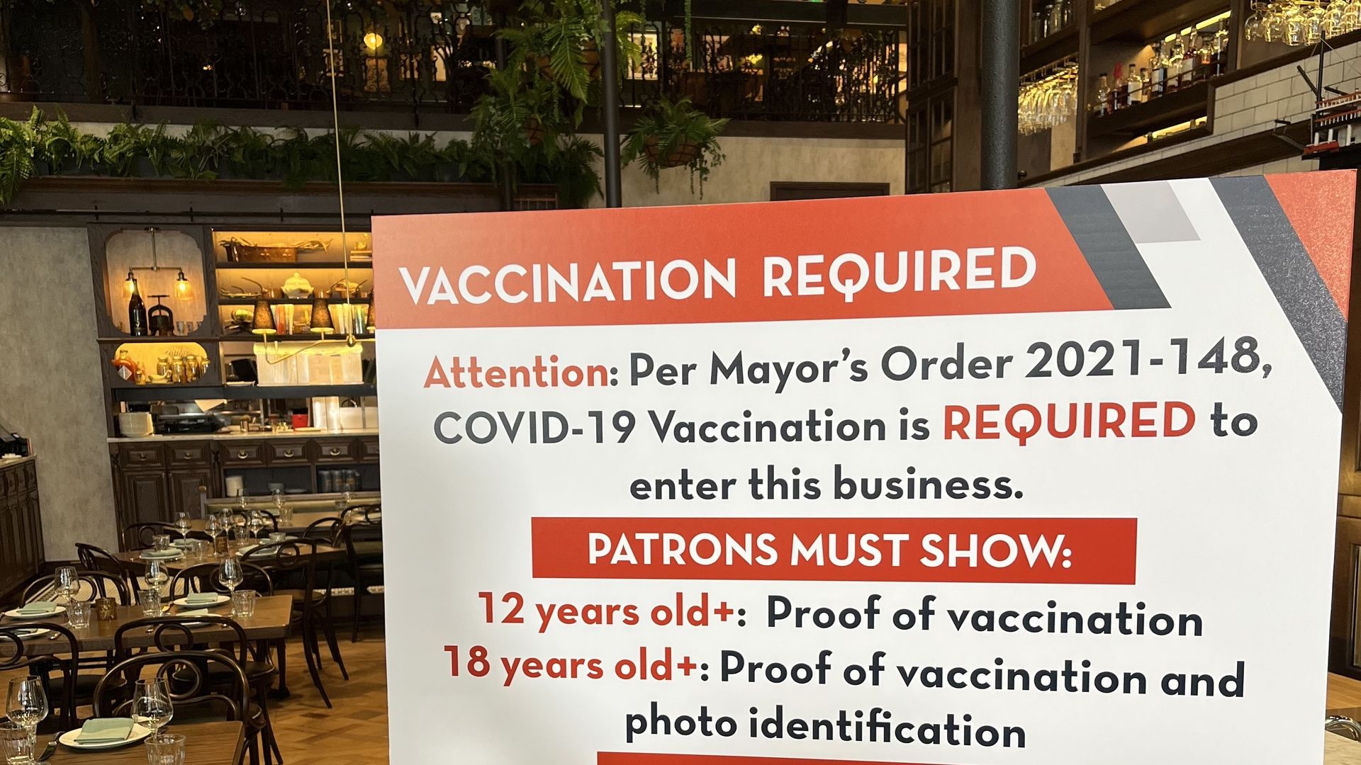 A poster with details of the vaccine requirement inside a restaurant