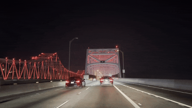 Cars approach the beams of one of the Crescent City Connection bridges.