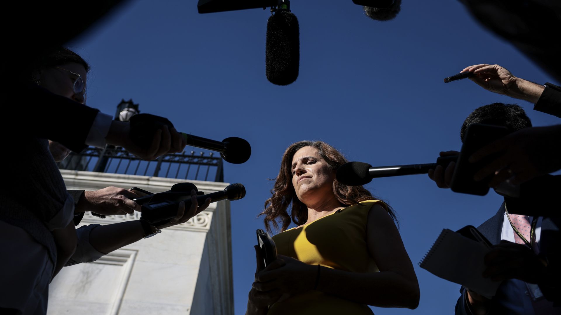 Rep. Nancy Mace is seen surrounded by reporters after she voted to hold Steve Bannon in contempt of Congress.