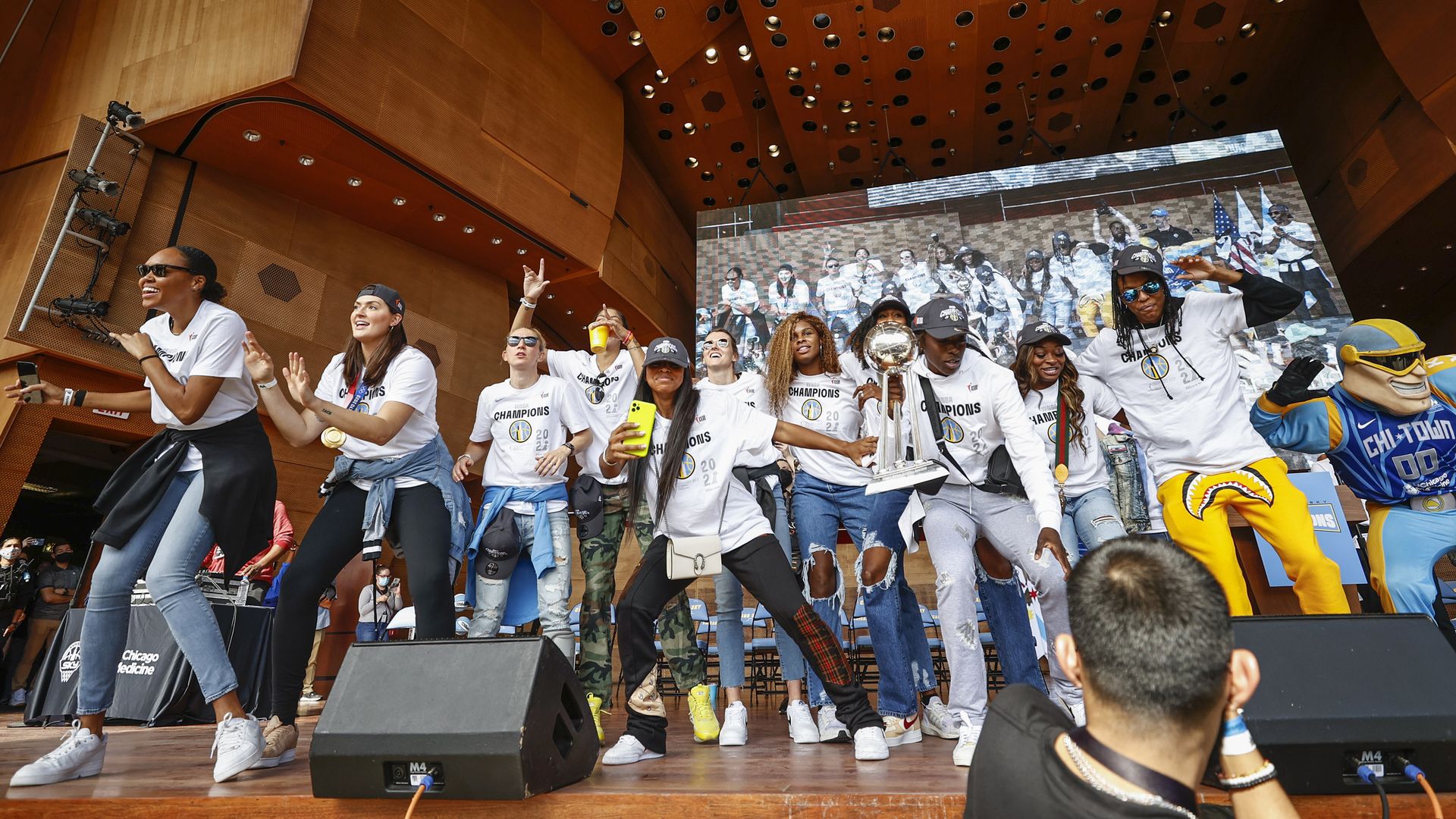 Female basketball players celebrating on stage