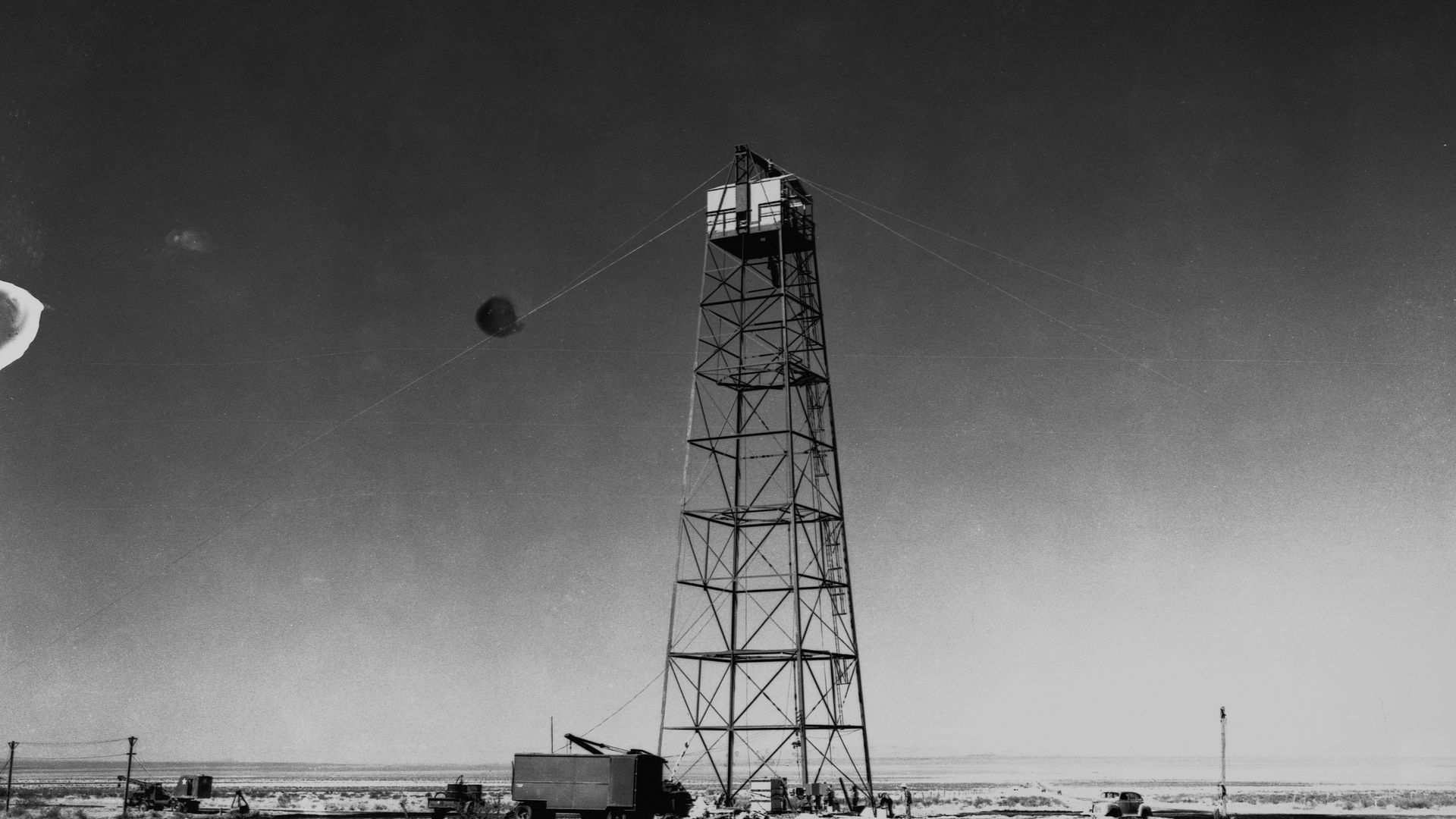 A black and white photo of a wooden tower in the Nevada desert.