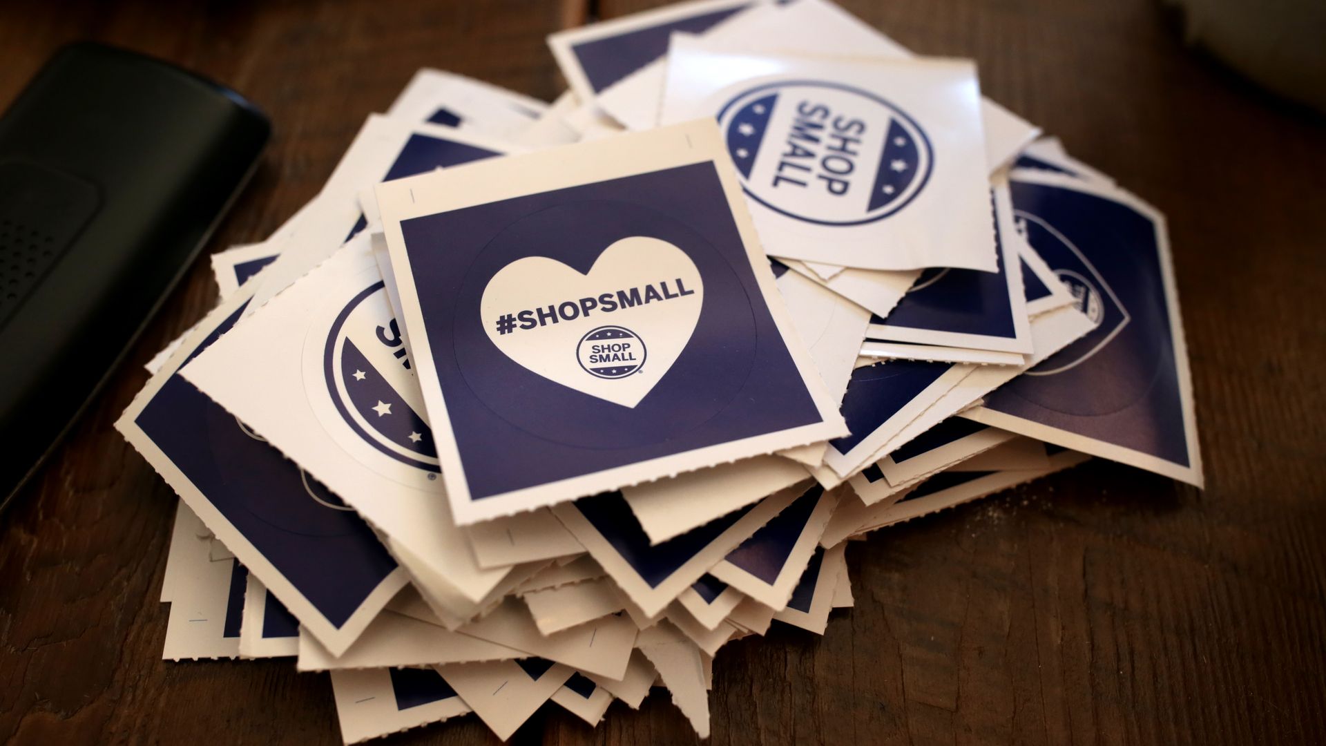 A stack of stickers that read: "Shop Small."