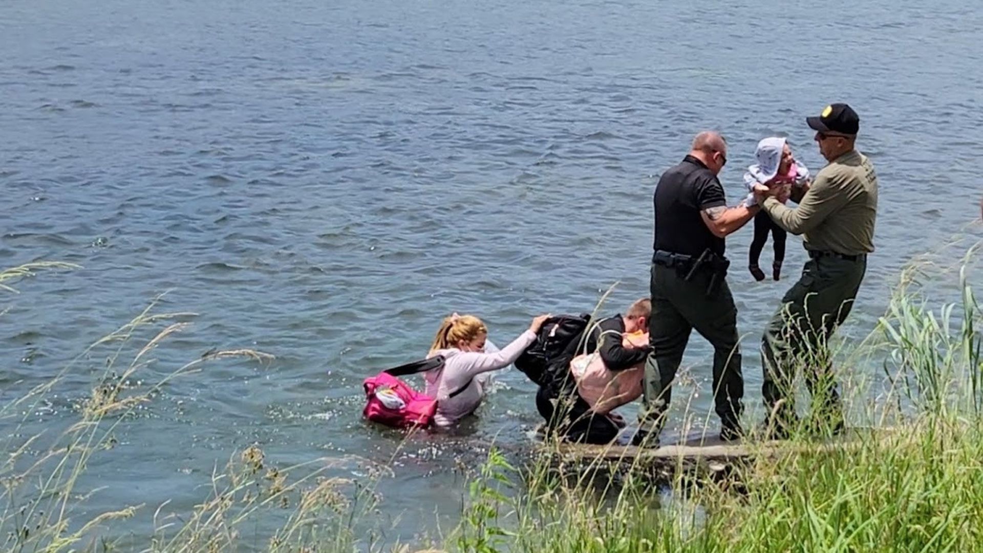 A photo of Iowa troopers holding a baby during a river rescue earlier this month on the Texas-Mexico border. 