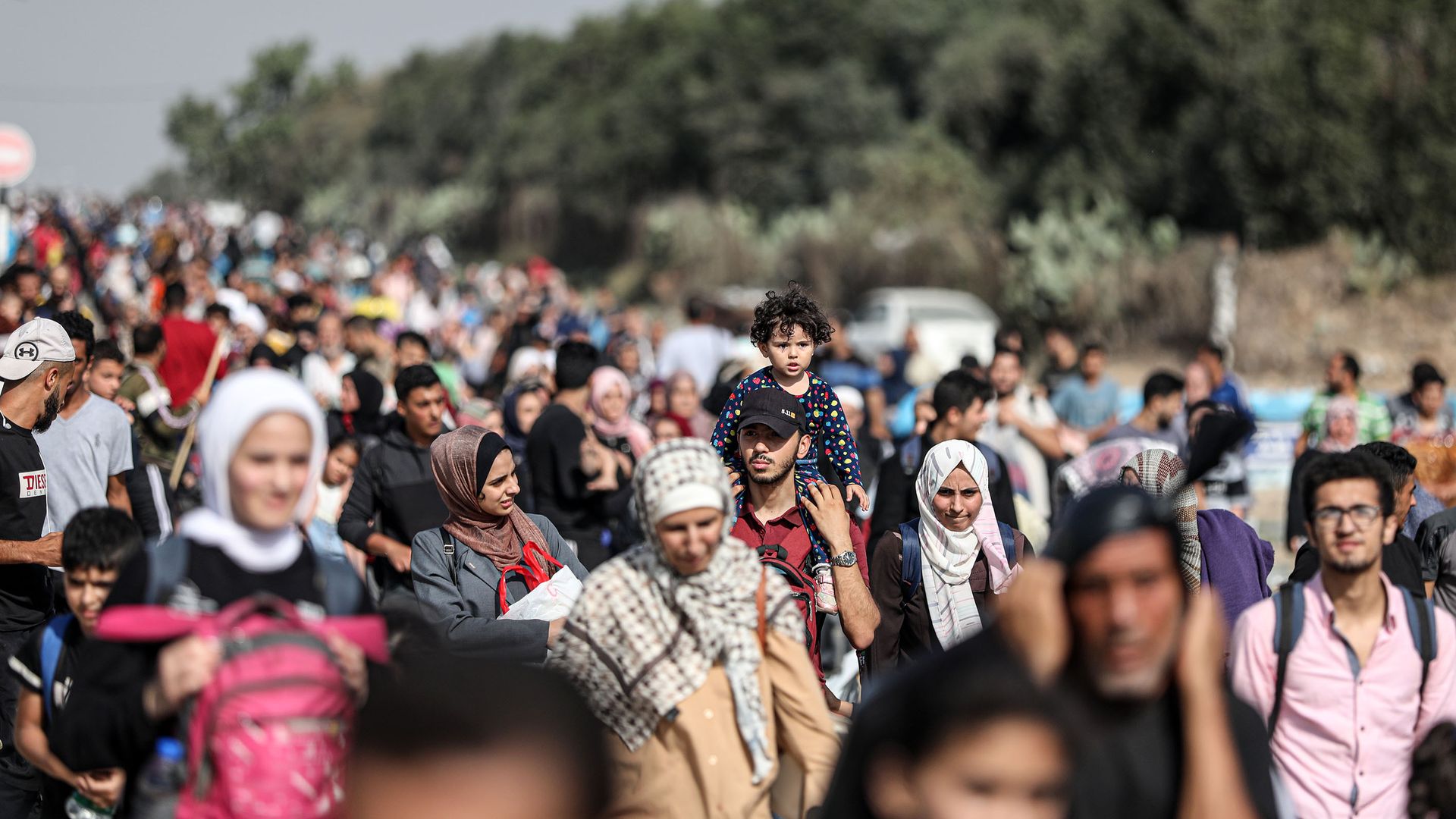 Groups of Palestinian citizens evacuate northern Gaza on foot.