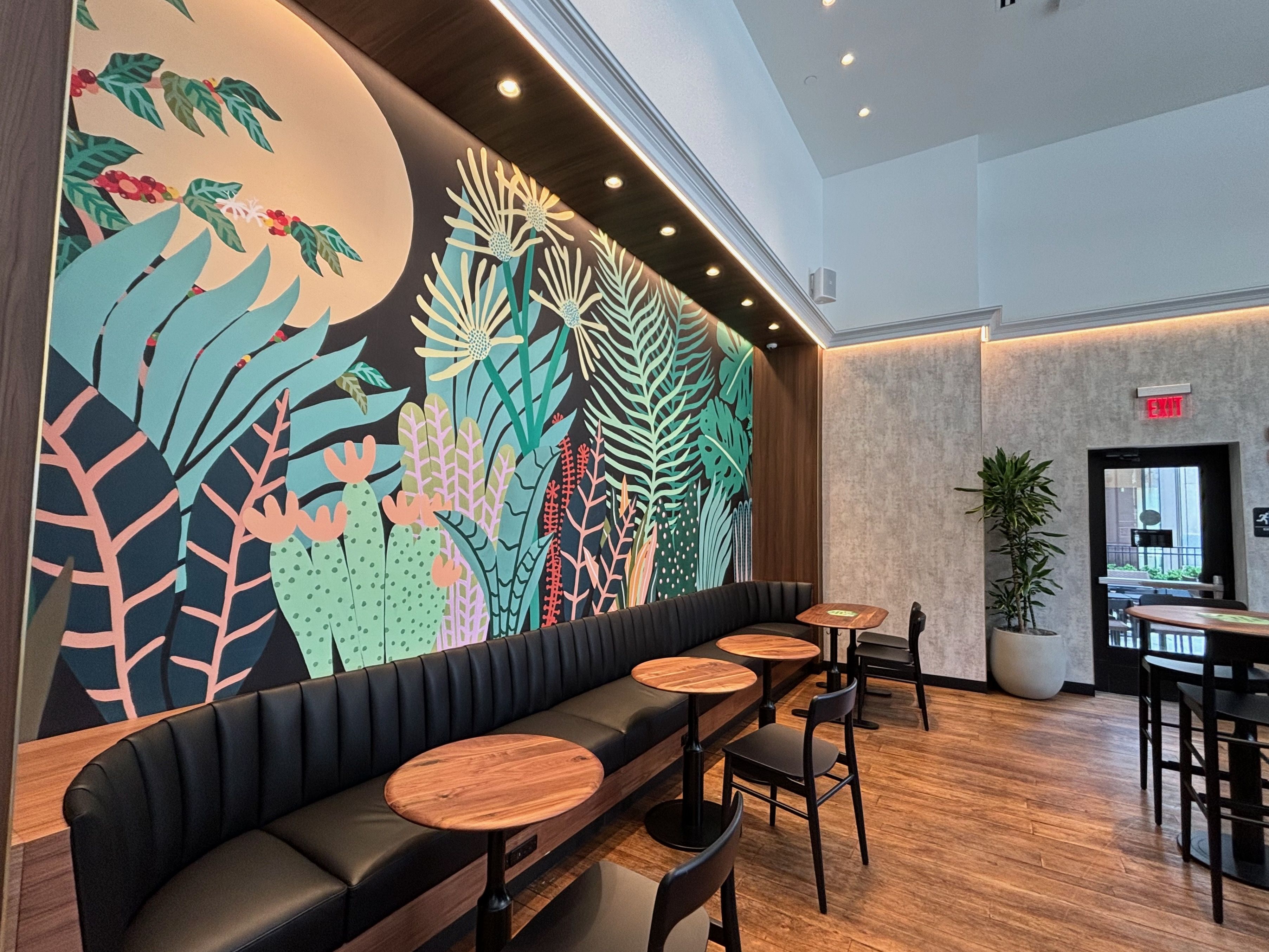A mural in front of a booth and chairs