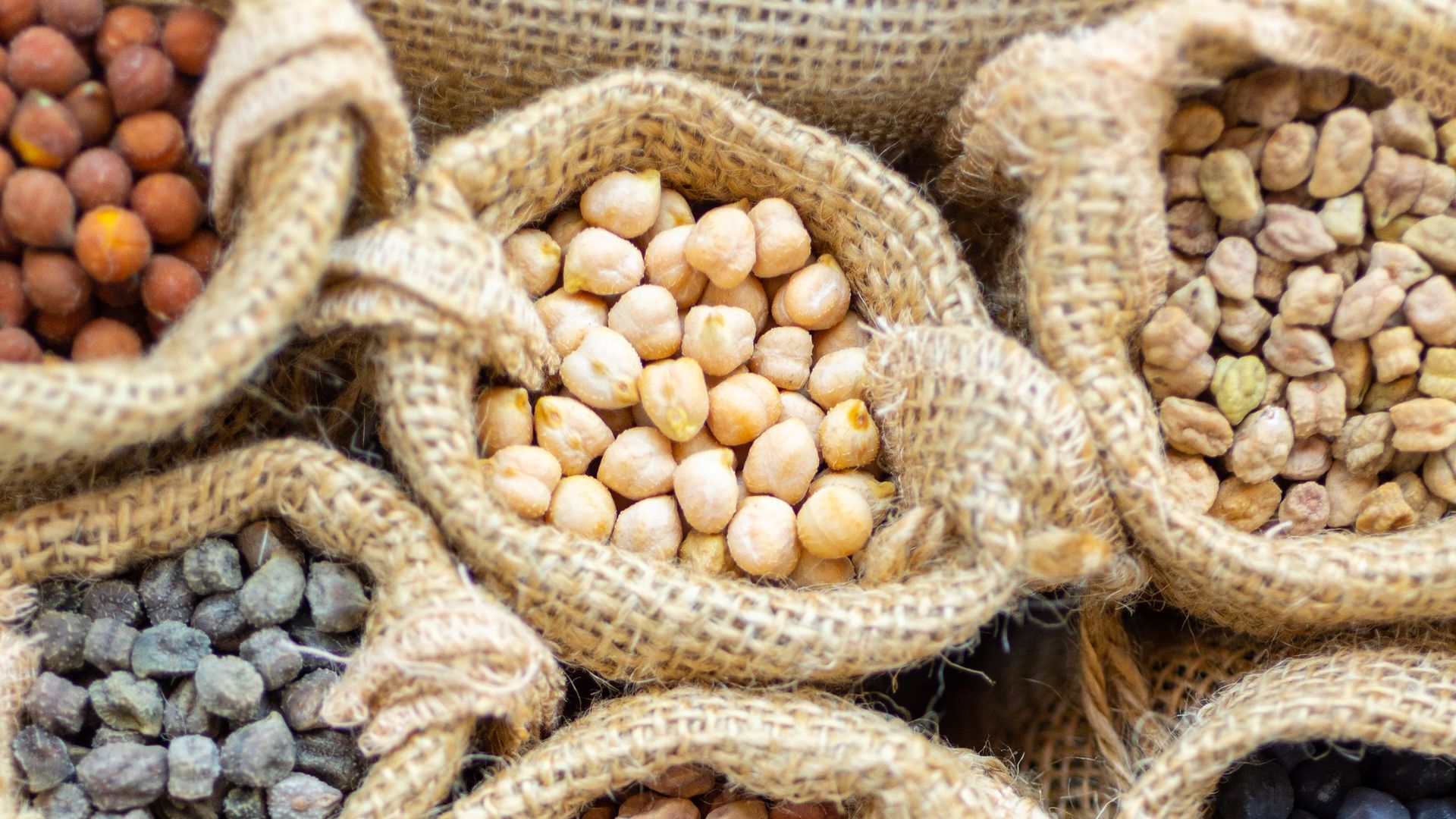 Bags of differently colored chickpeas.