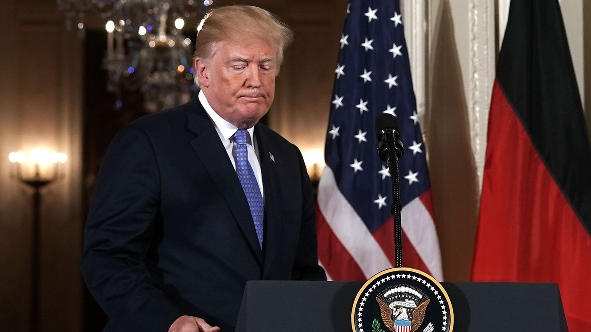 Donald Trump stands at his podium during a press conference.