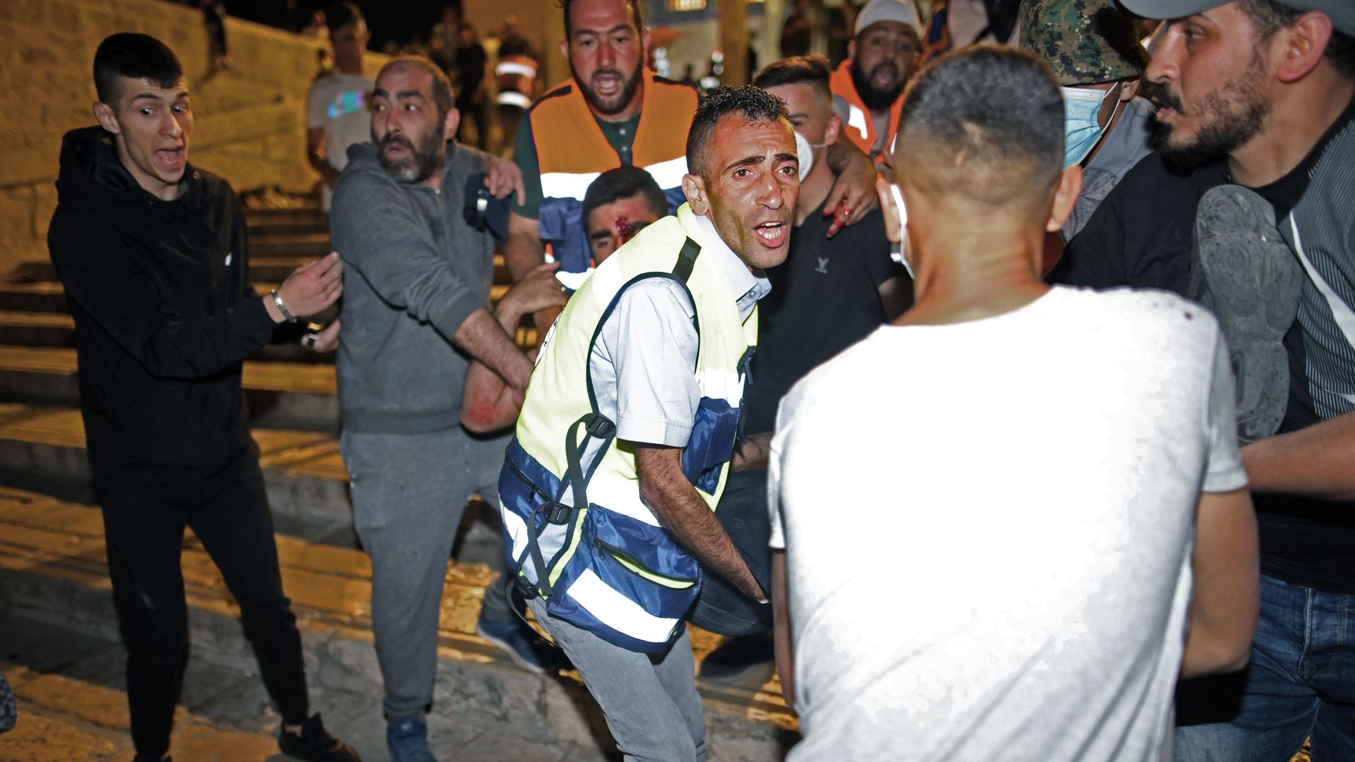 An injured man is carried away as Israeli security forces clash with Palestinian protesters at the al-Aqsa mosque compound in Jerusalem