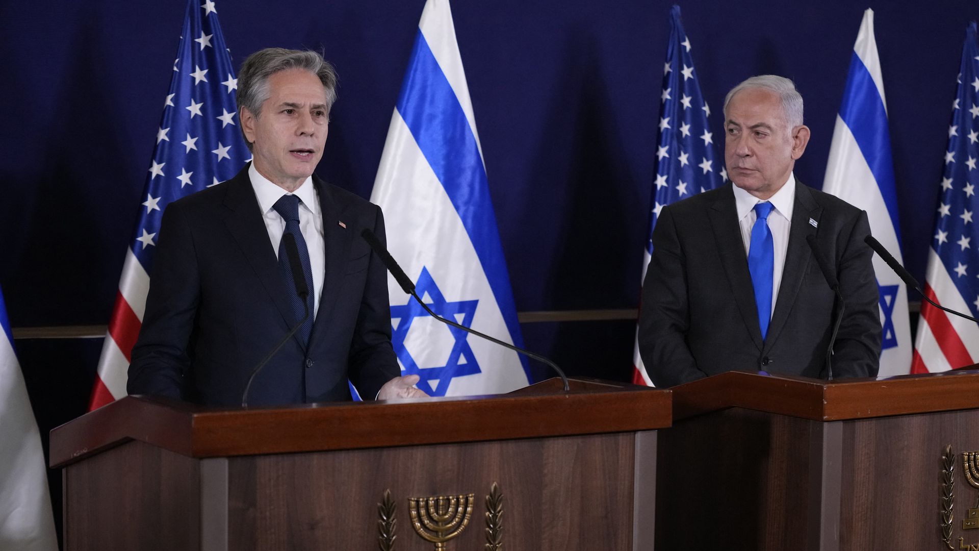 Israeli Prime Minister Benjamin Netanyahu (R) looks on as US Secretary of State Antony Blinken gives statements to the media in Tel Aviv on October 12, 2023.