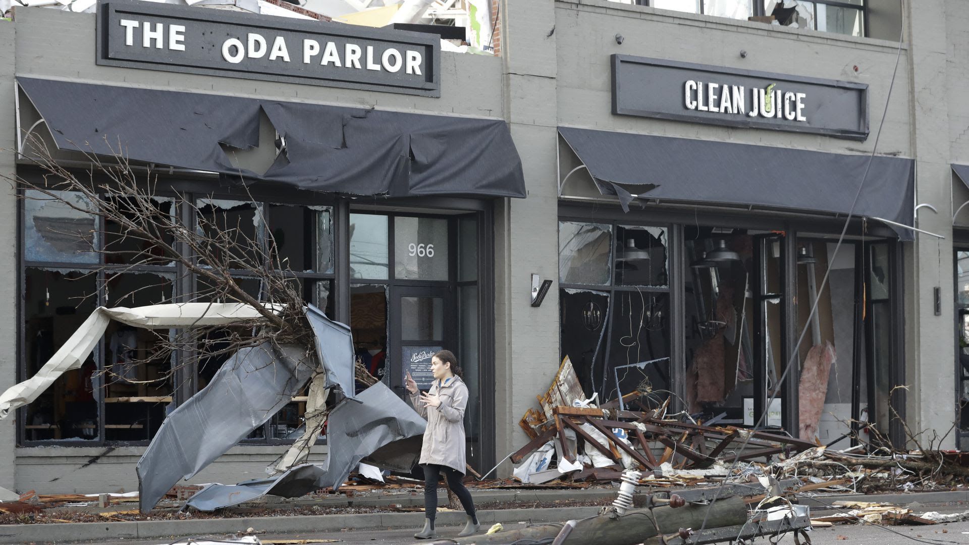 A scene of damage following the March, 2020 tornado in Nashville. Signs and trash are askew. 