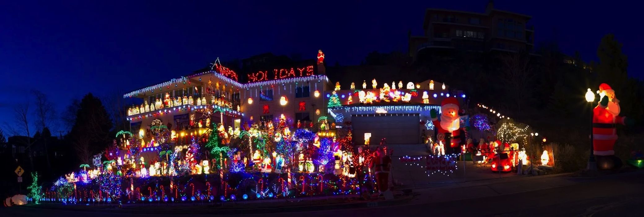 A house with copious blow molds and other Christmas decorations