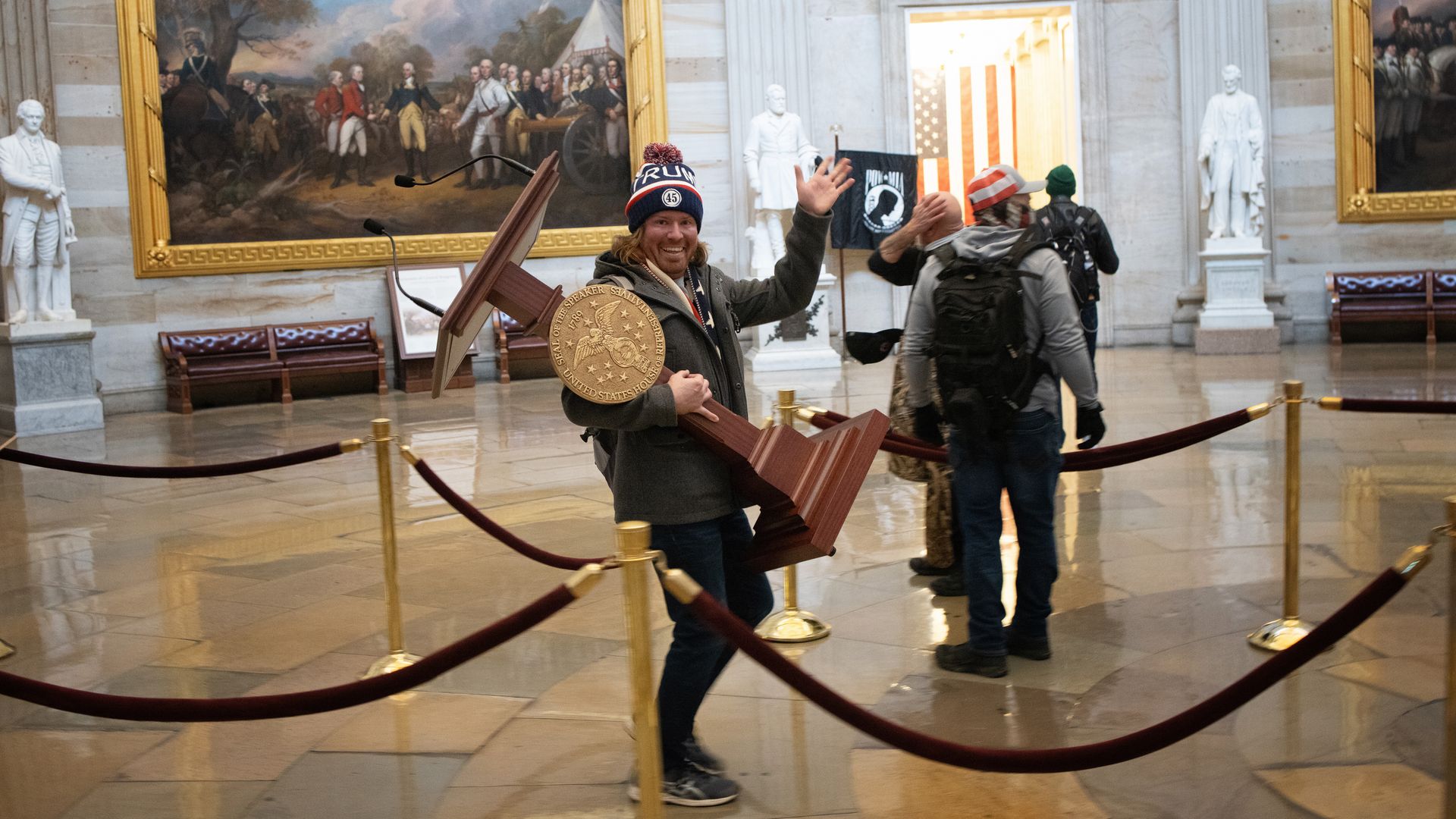  pro-Trump protester carries the lectern of U.S. Speaker of the House Nancy Pelosi through the Rotunda of the U.S. Capitol 