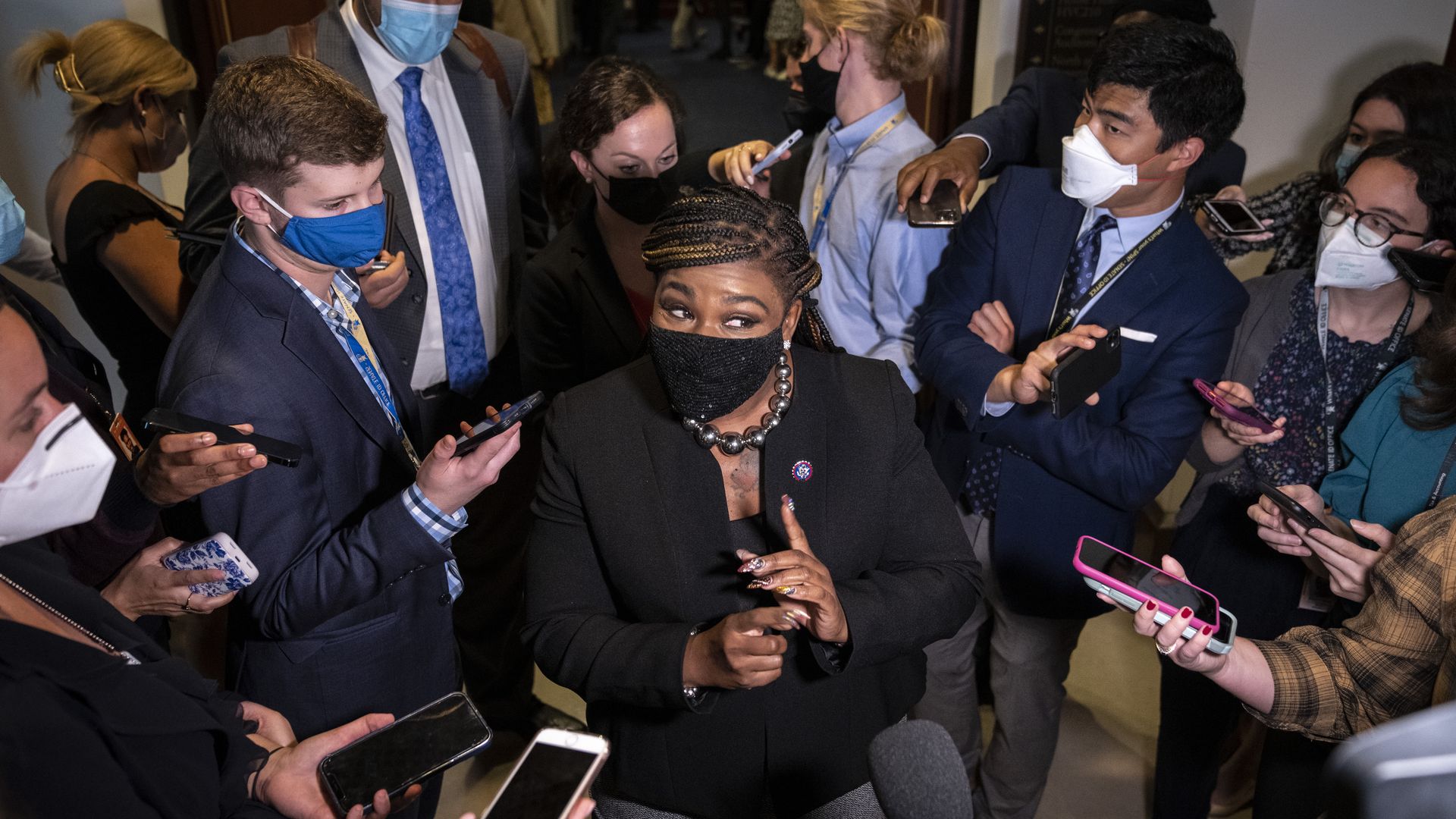 Rep. Cori Bush is seen surrounded by reporters on Thursday.