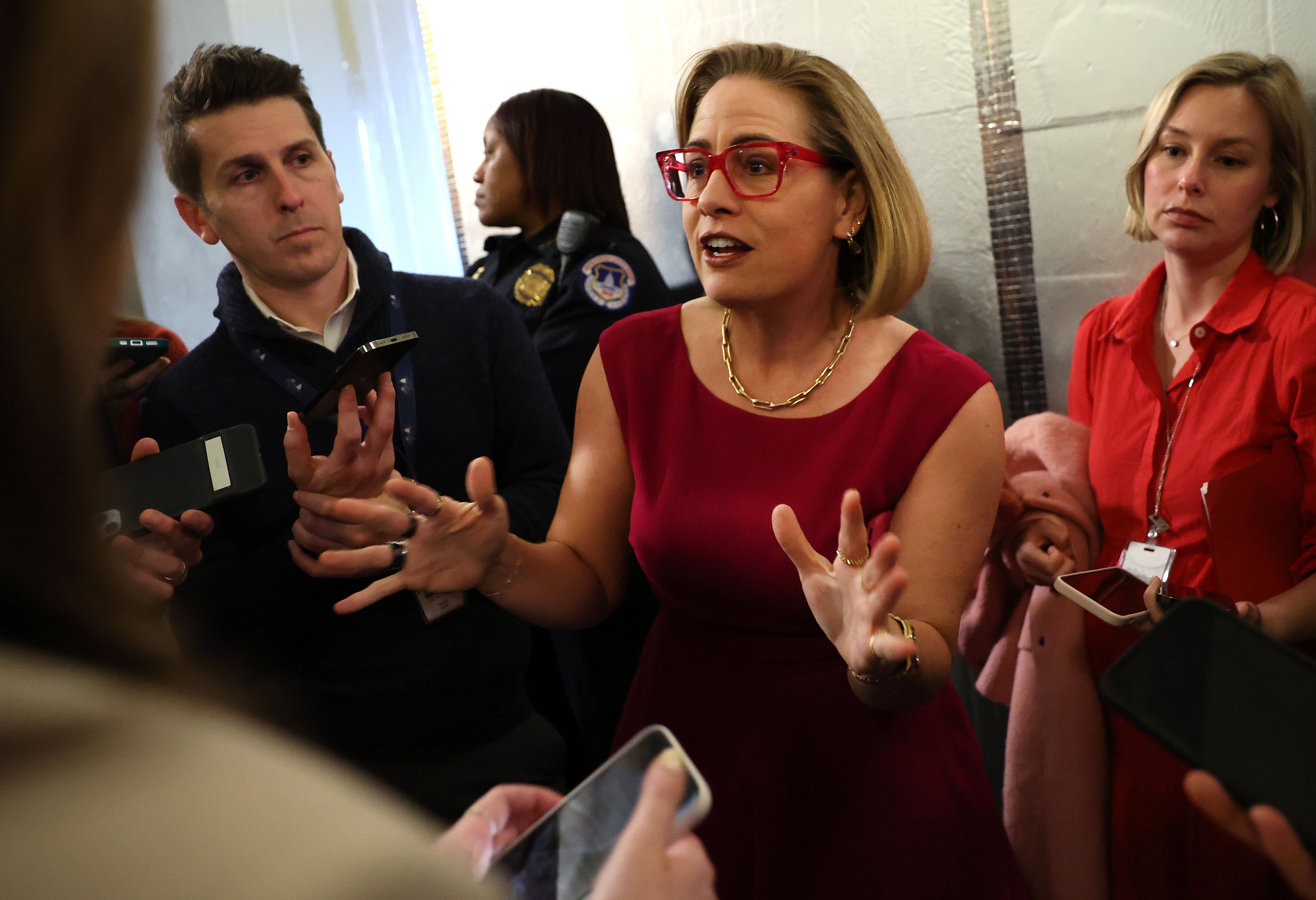 Sen. Kyrsten Sinema speaks to reporters on Capitol Hill earlier this month.