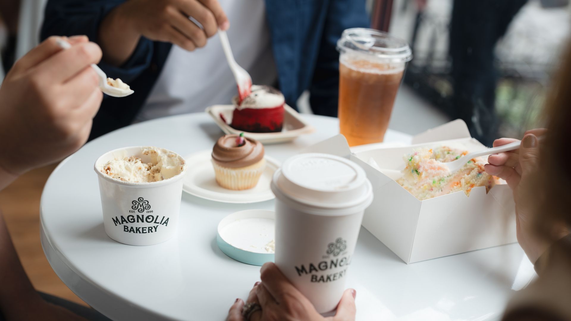People try Magnolia Bakery products from beverages to desserts.