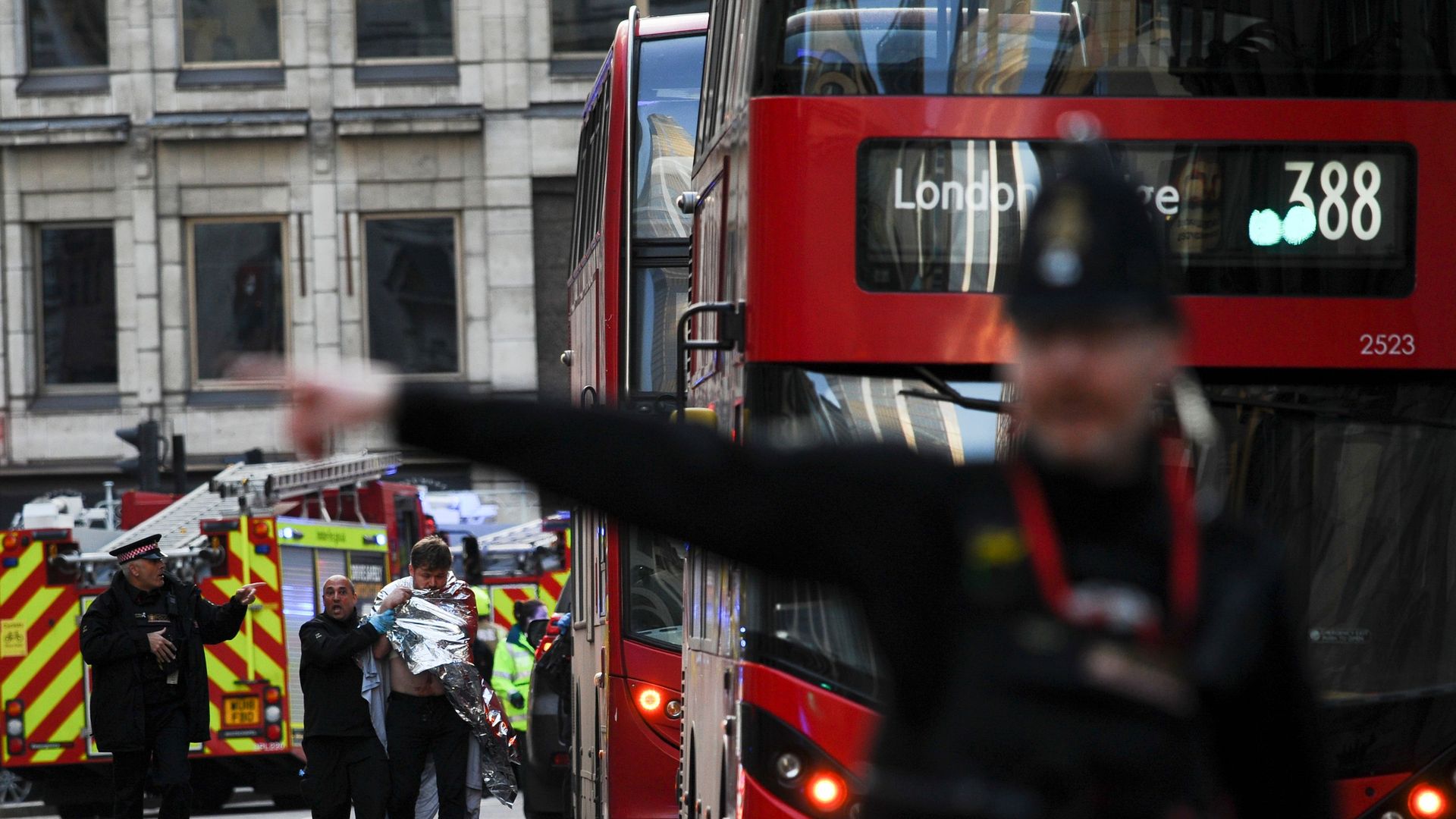 Police assist an injured man near London Bridge in London, on November 29, 2019 after reports of shots being fired on London Bridge.