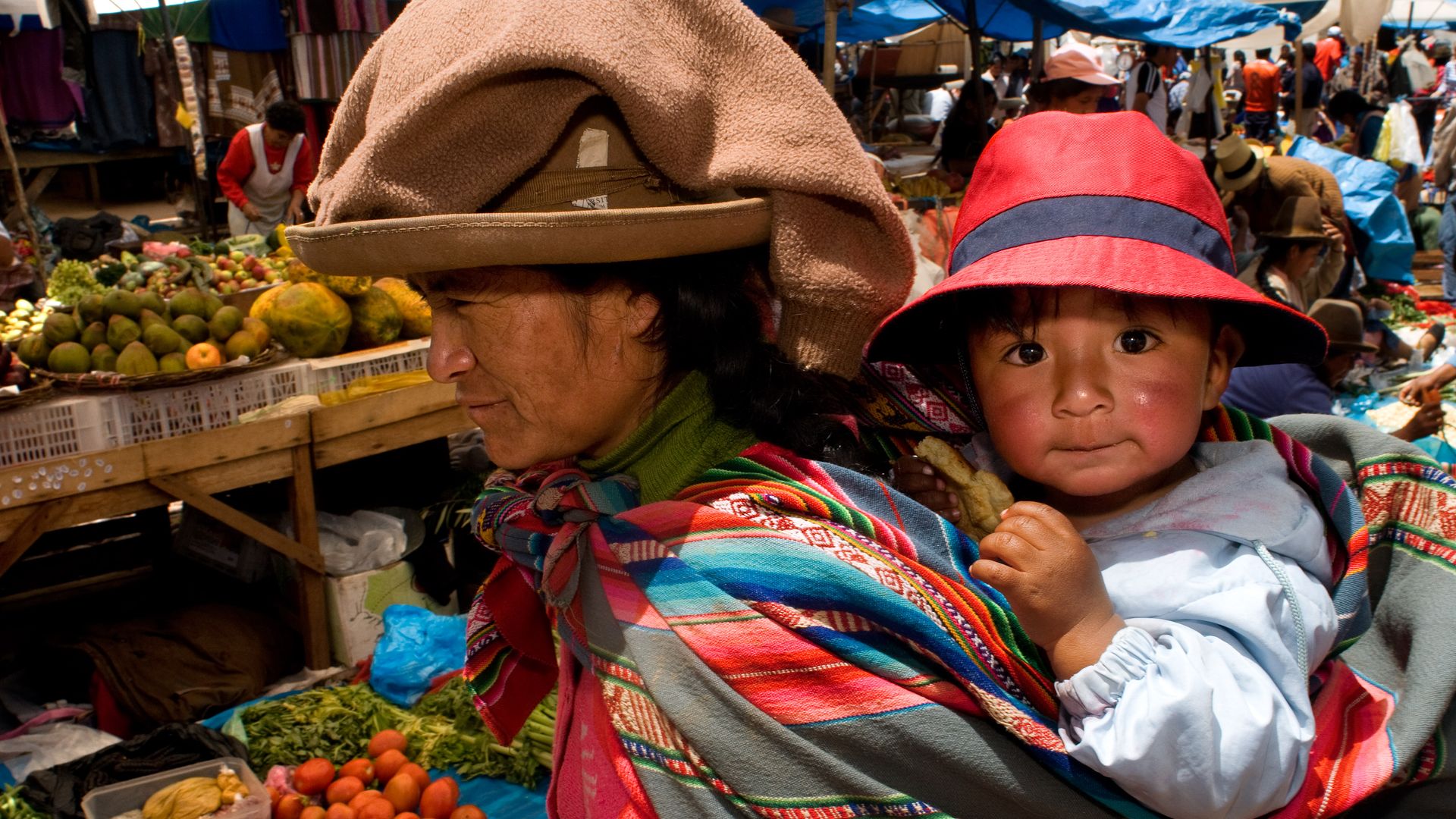 A mother and her son dressed in a traditional costume in Pisac Sunday market day. Pisac. Sacred Valley.