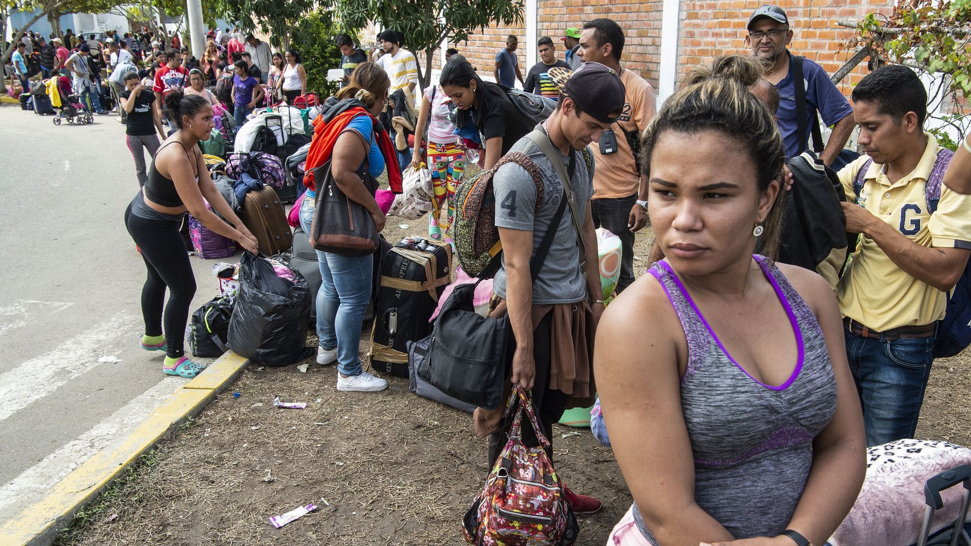 Venezuelan migrants lined up with their bags