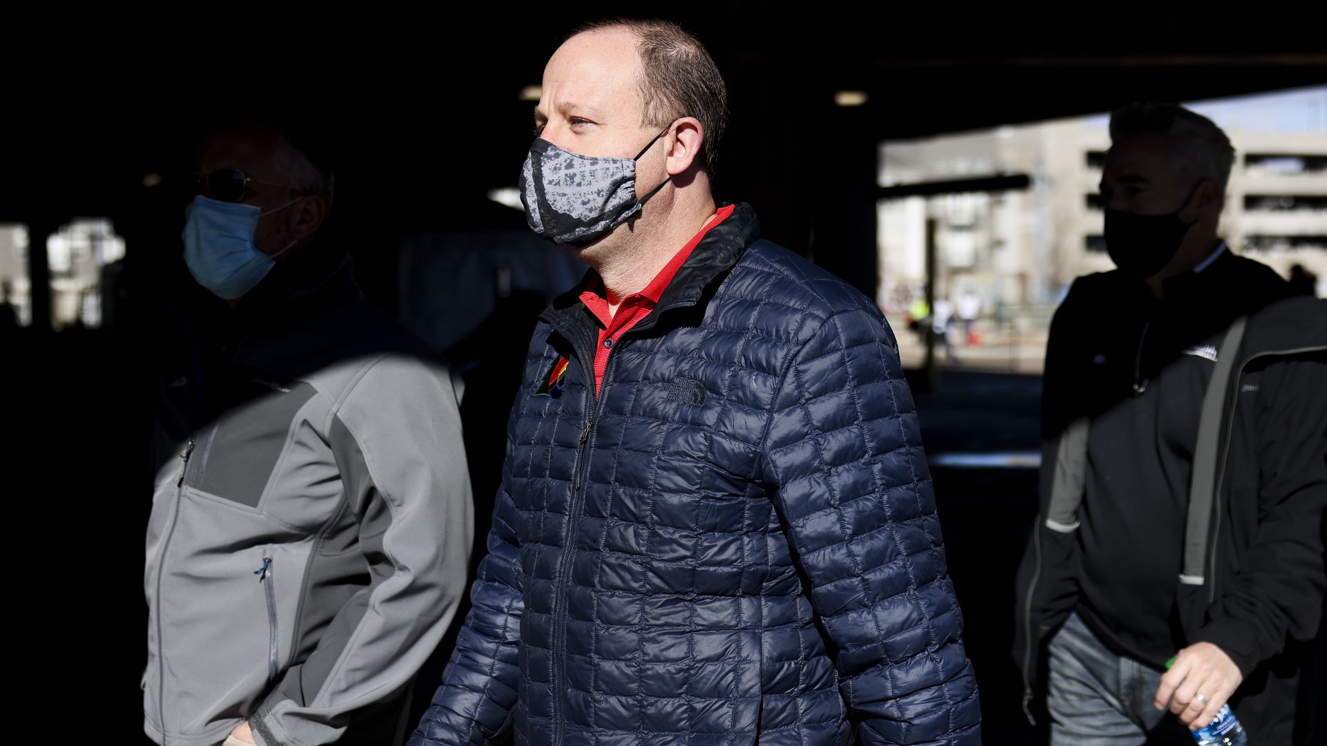 Colorado Gov. Jared Polis, center, visits a mass COVID-19 vaccination event.