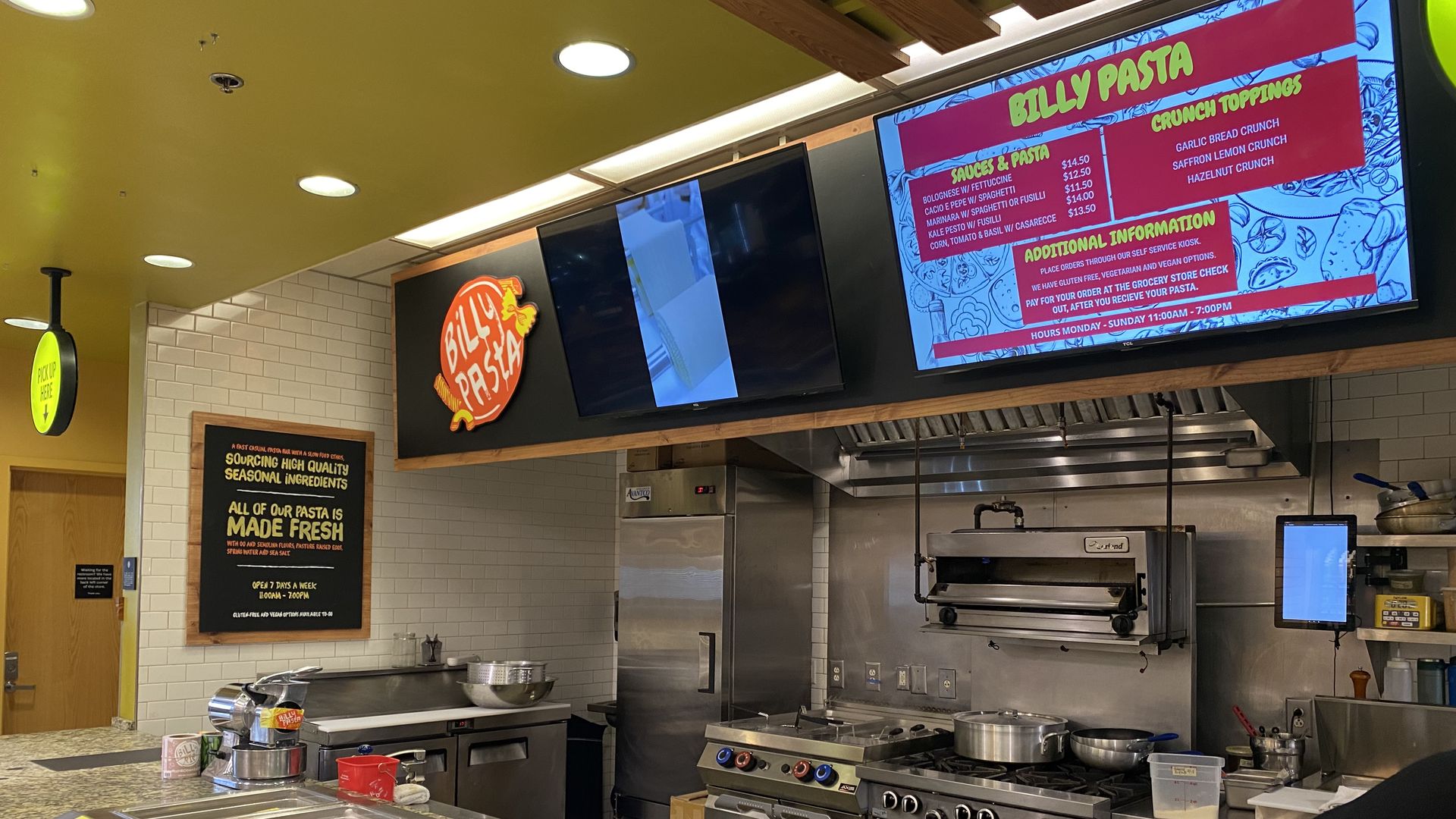 Shows an open kitchen with trays where food can be set once it's cooked.