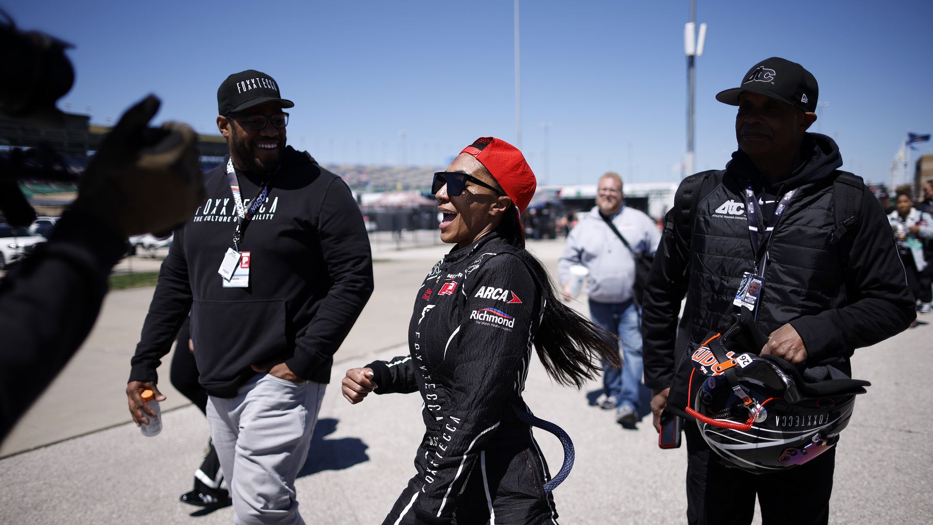 Dystany Spurlock in a red backwards hat and sunglasses smiling and dancing