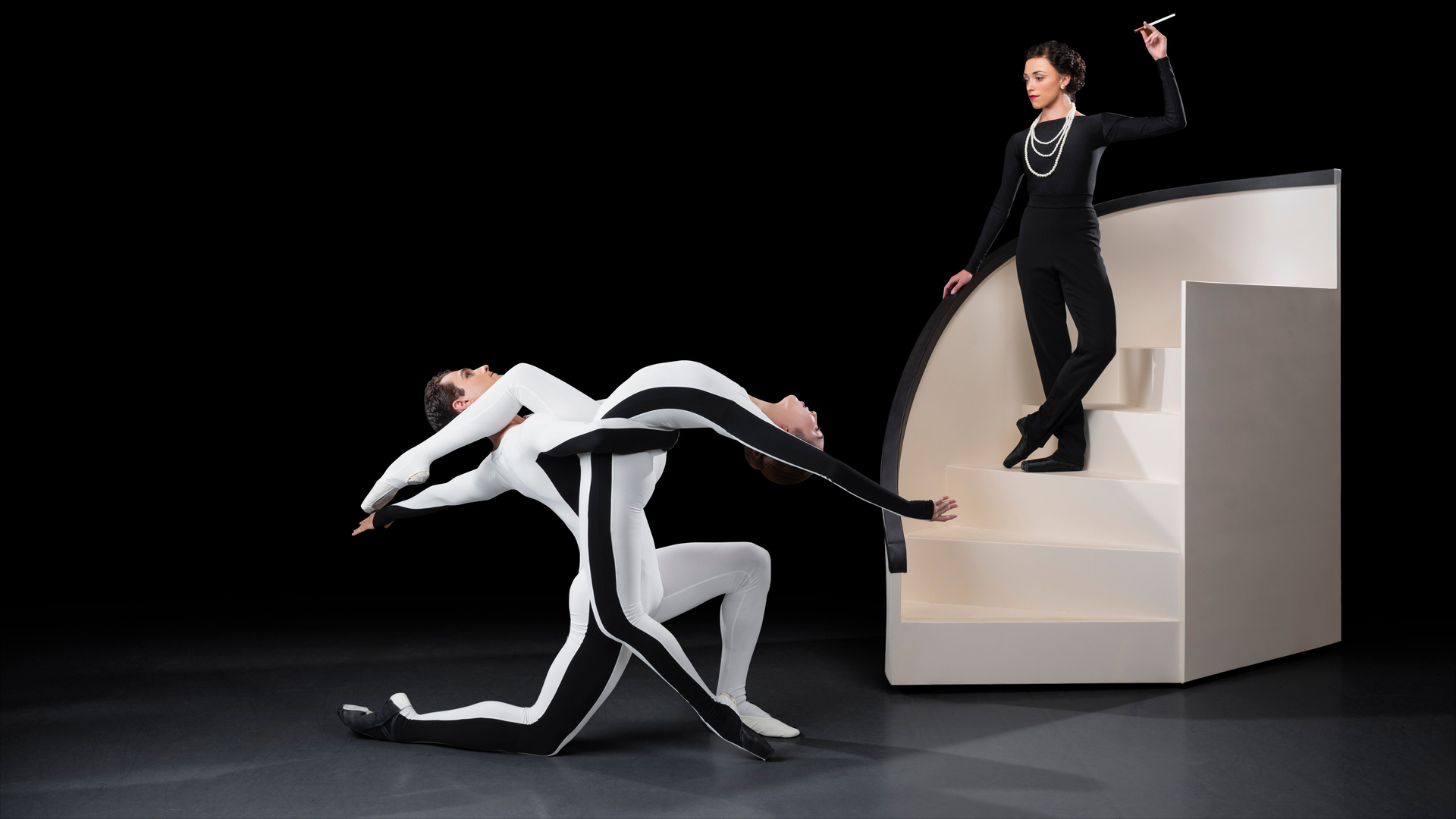 Atlanta Ballet Dancers Sojung Lee, Severin Brotschul pose as the Coco Logo, and Brooke Giliam poses as its Shadow.