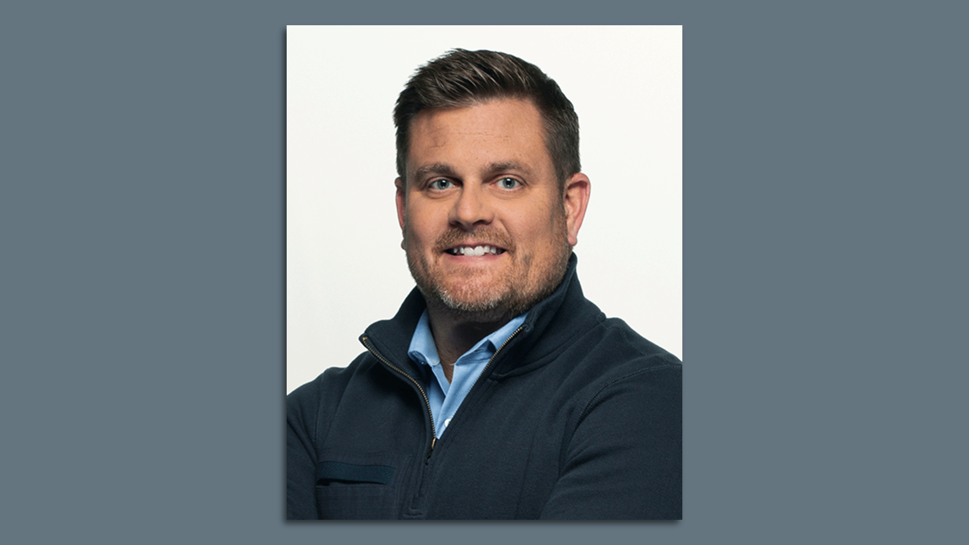 A headshot of Brian Thompson