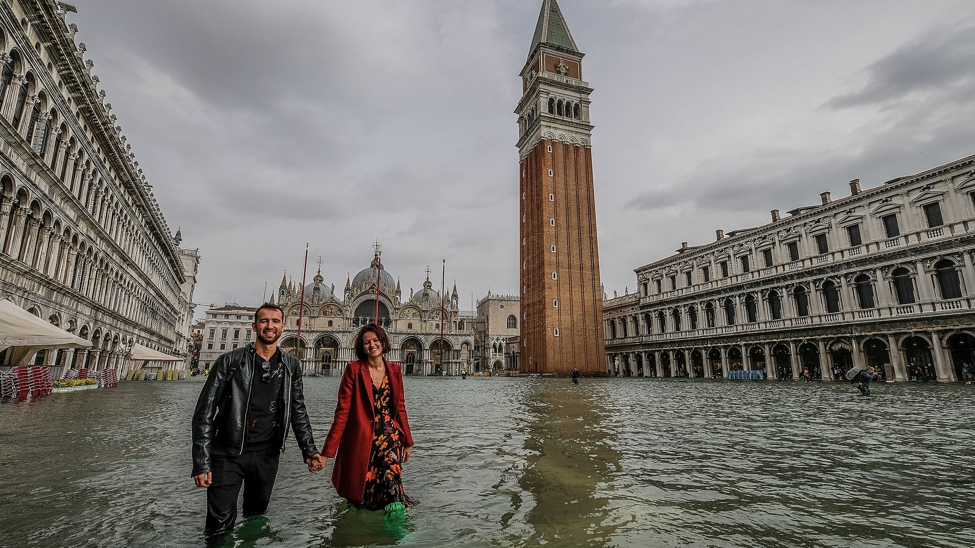 Tourists walk through a flooded Venice, Italy during the highest tide in a decade.