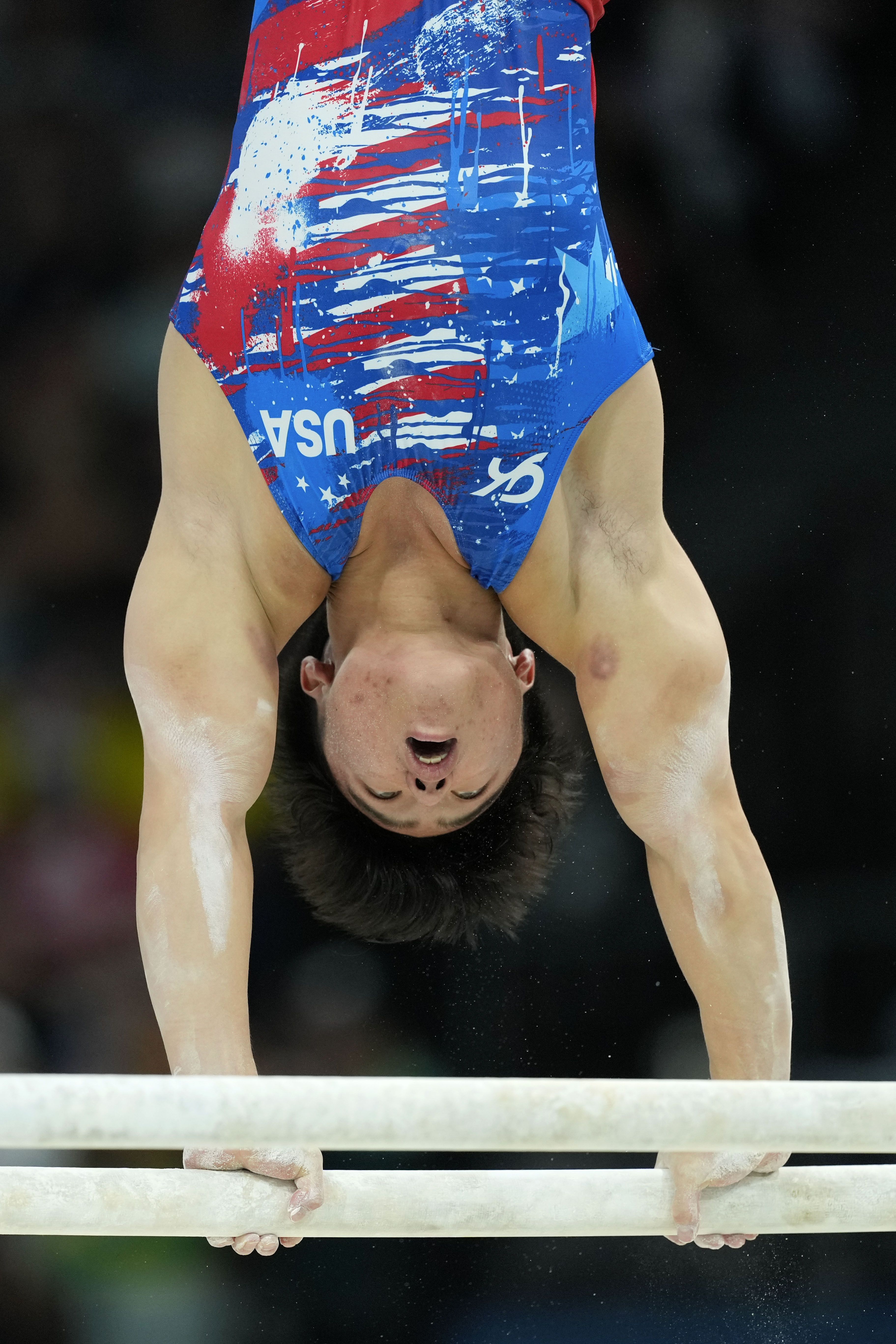 Asher Hong, of United States, competes on the parallel bars during a men's artistic gymnastics qualification round at the 2024 Summer Olympics