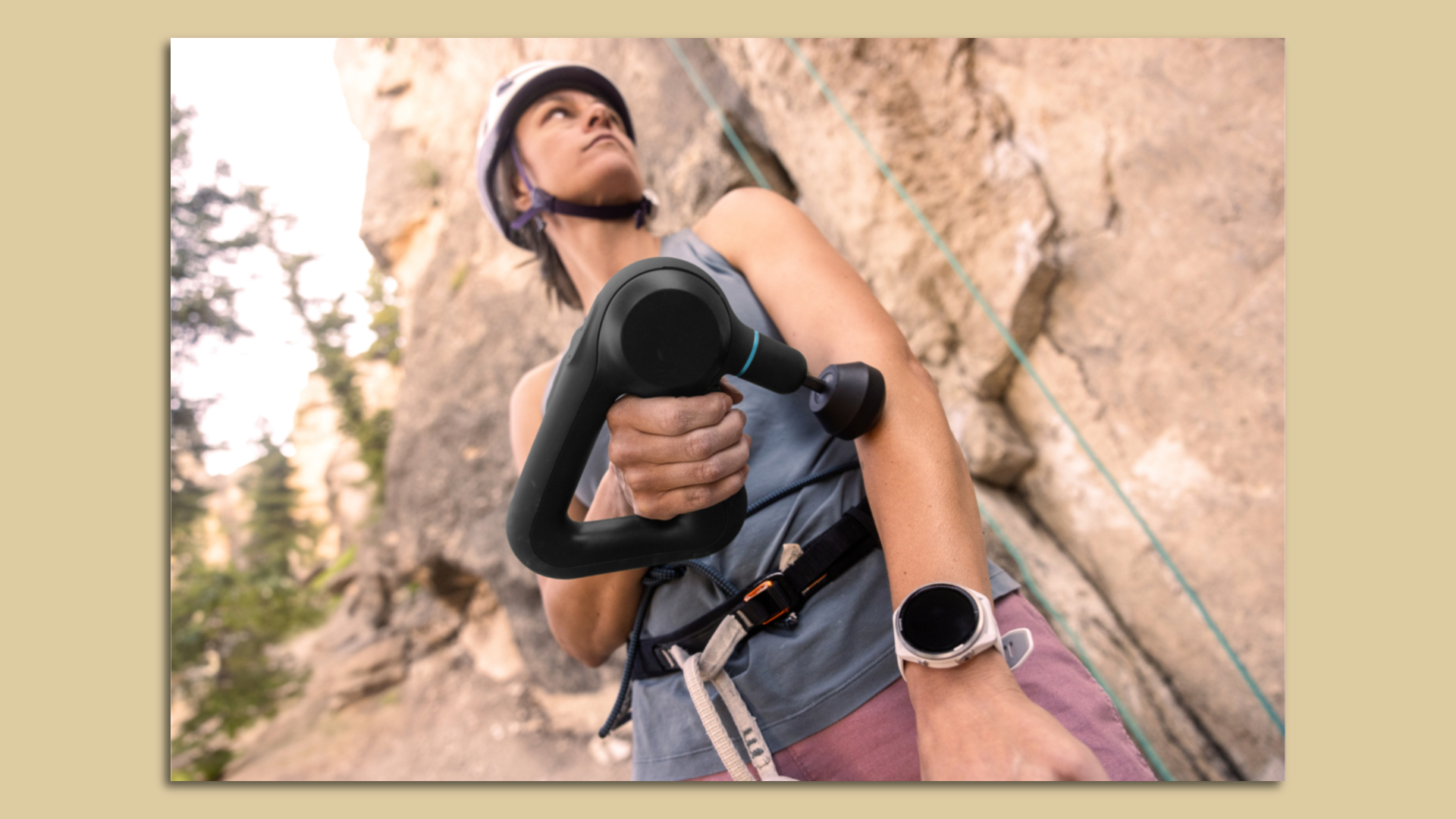 An athlete using a Theragun massager