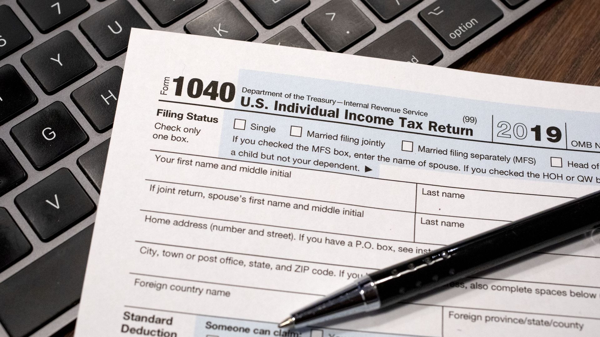 Image of an IRS tax form and a computer keyboard