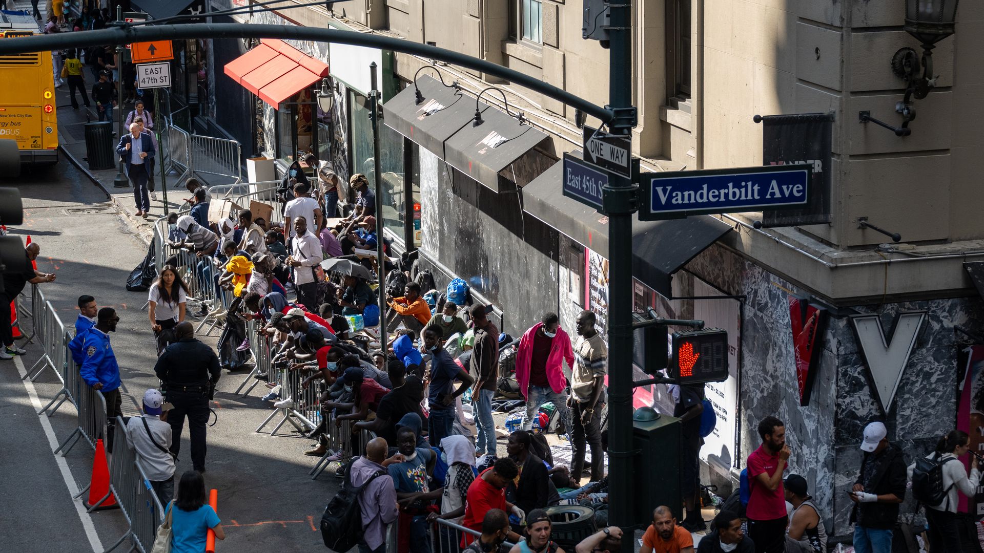Migrants on sidewalk outside Roosevelt Hotel