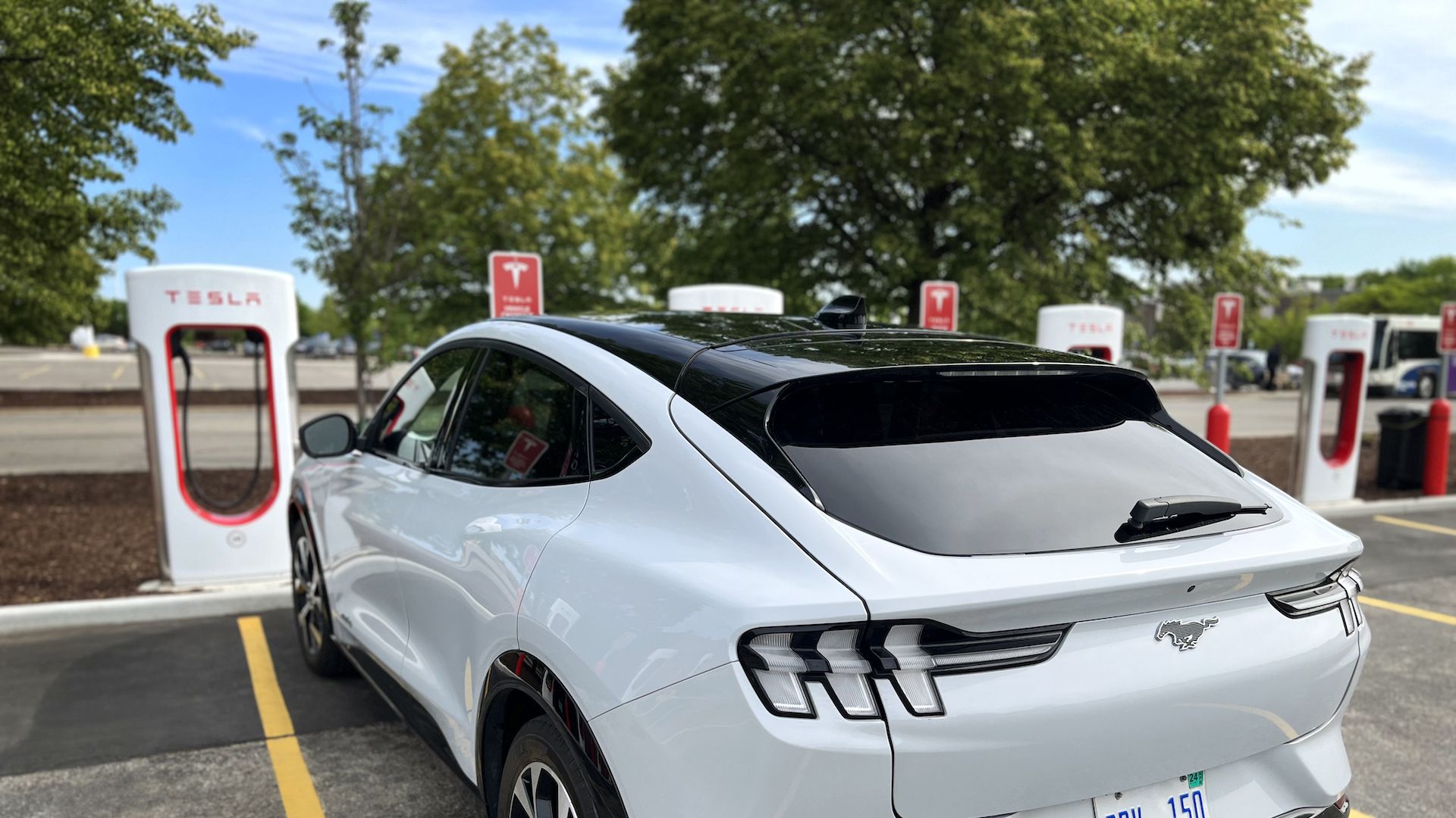 Photo of a Ford electric vehicle at a Tesla charging station
