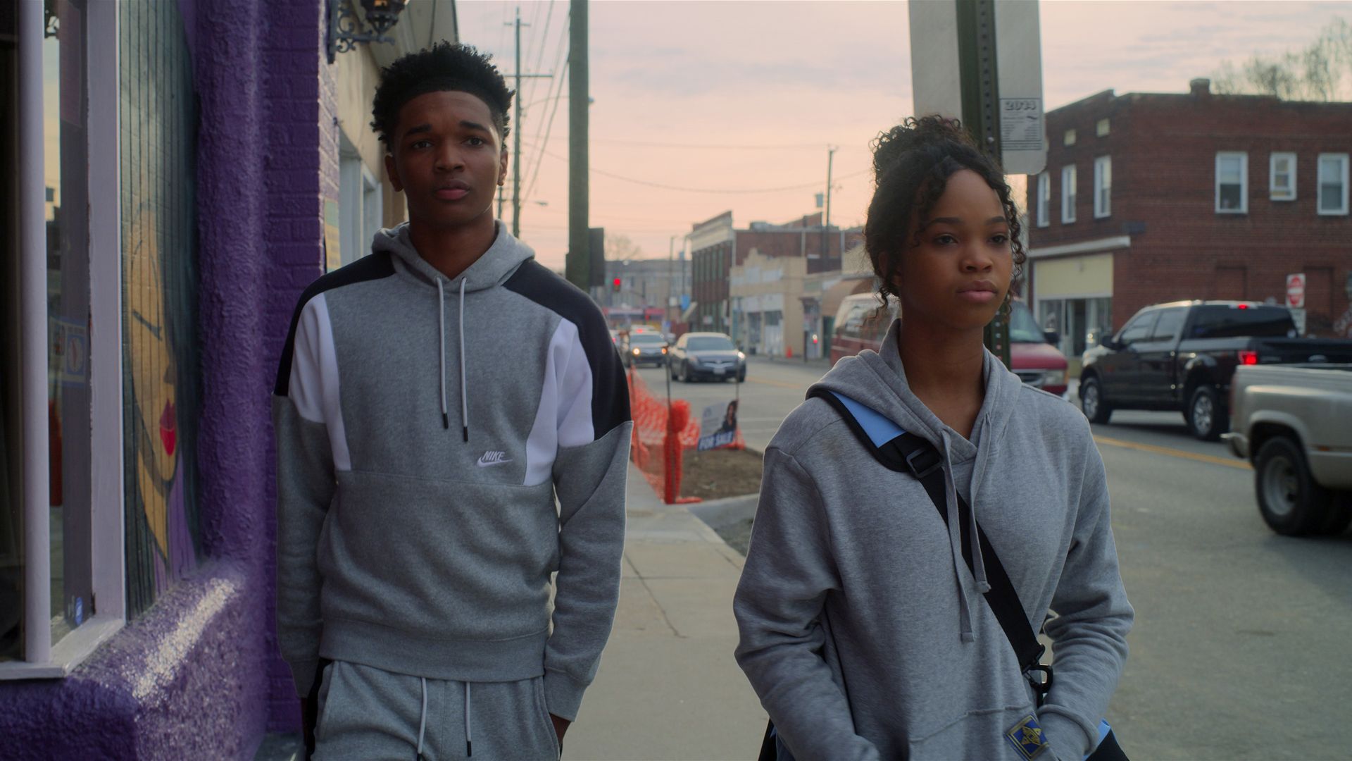 A couple walks down a city street - the street is in Richmond