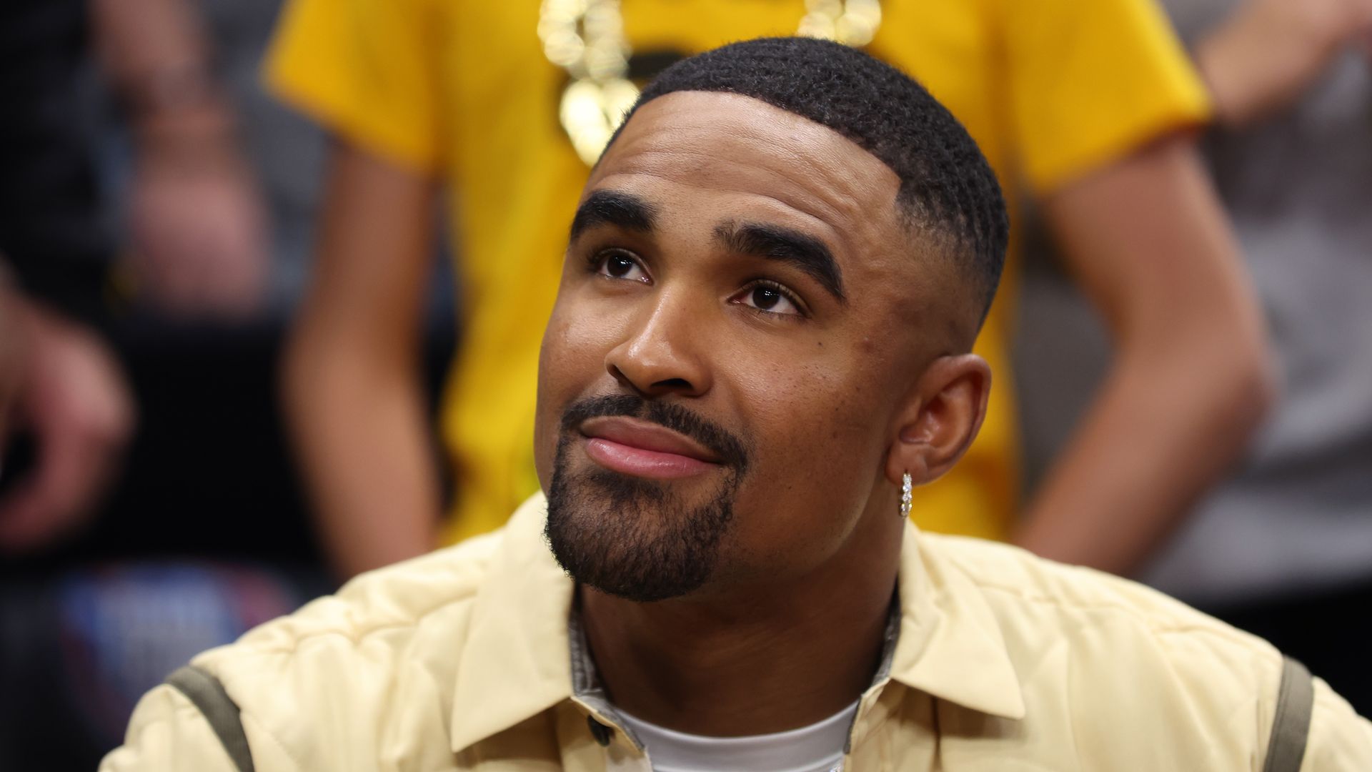 A photograph of Jalen Hurts smiling, looking away from the camera.