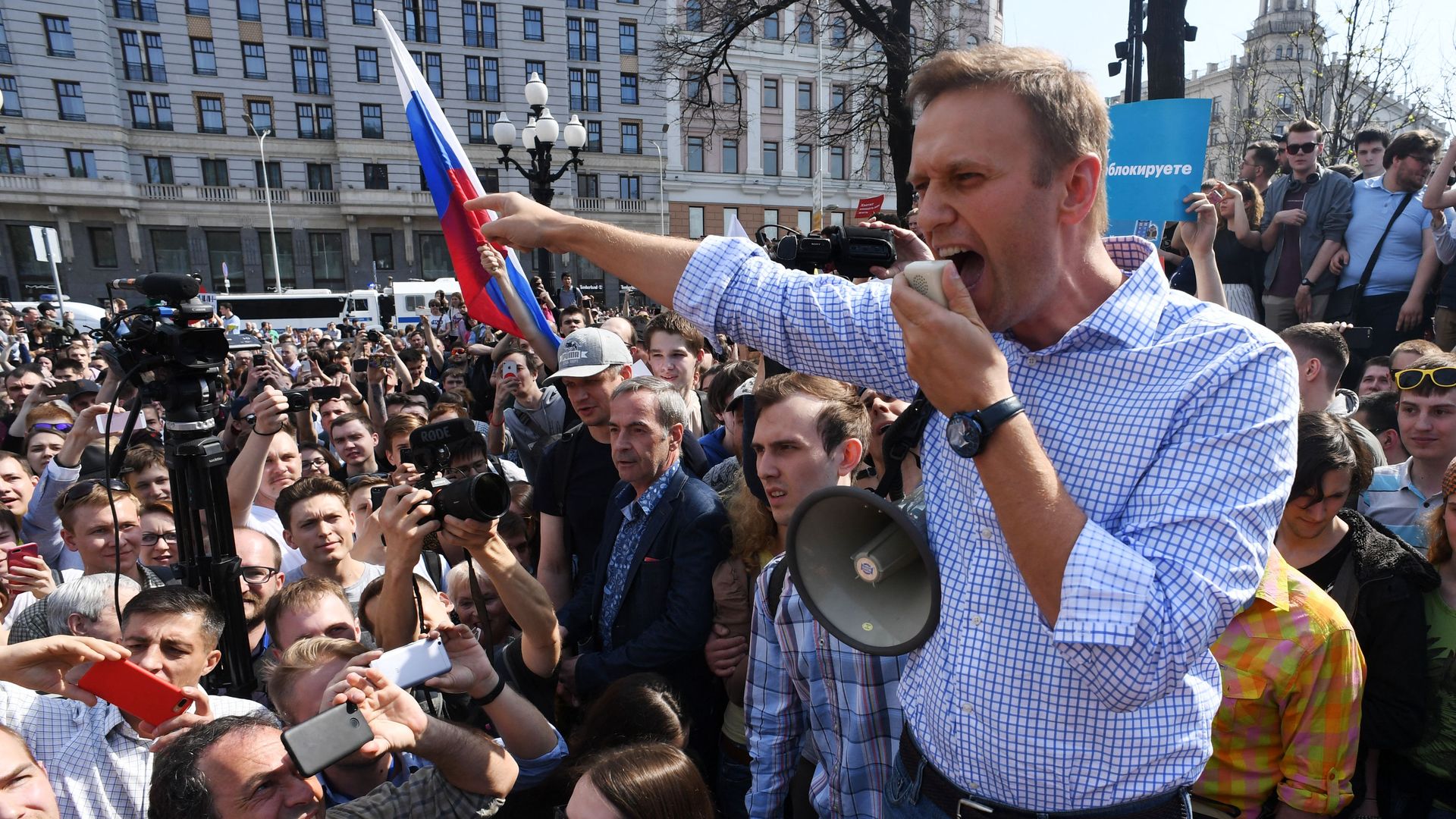 Alexei Navalny speaks during a protest with a crowd of people surrounding him