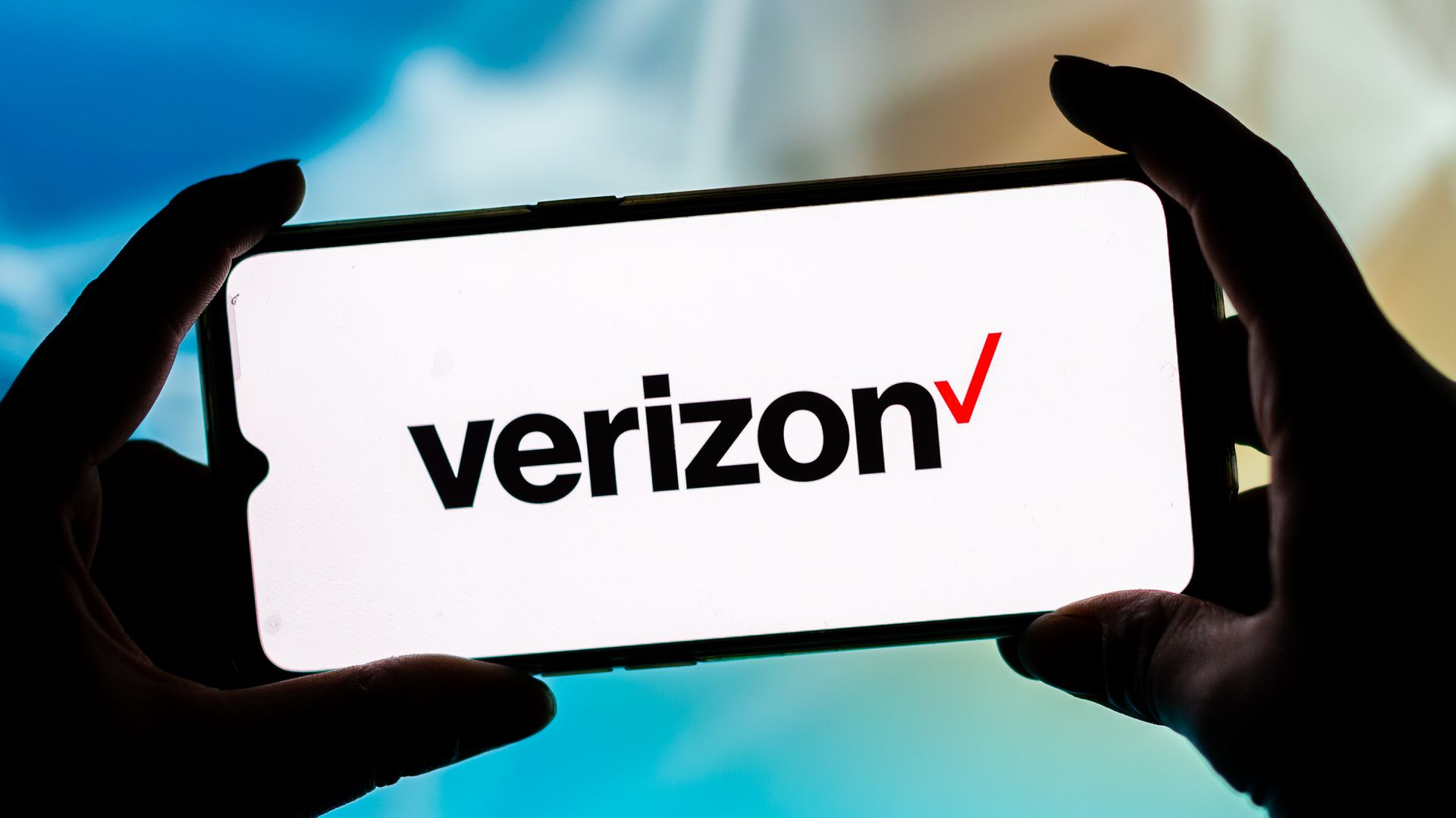 A photo illustration of a smartphone with the Verizon logo on the screen.