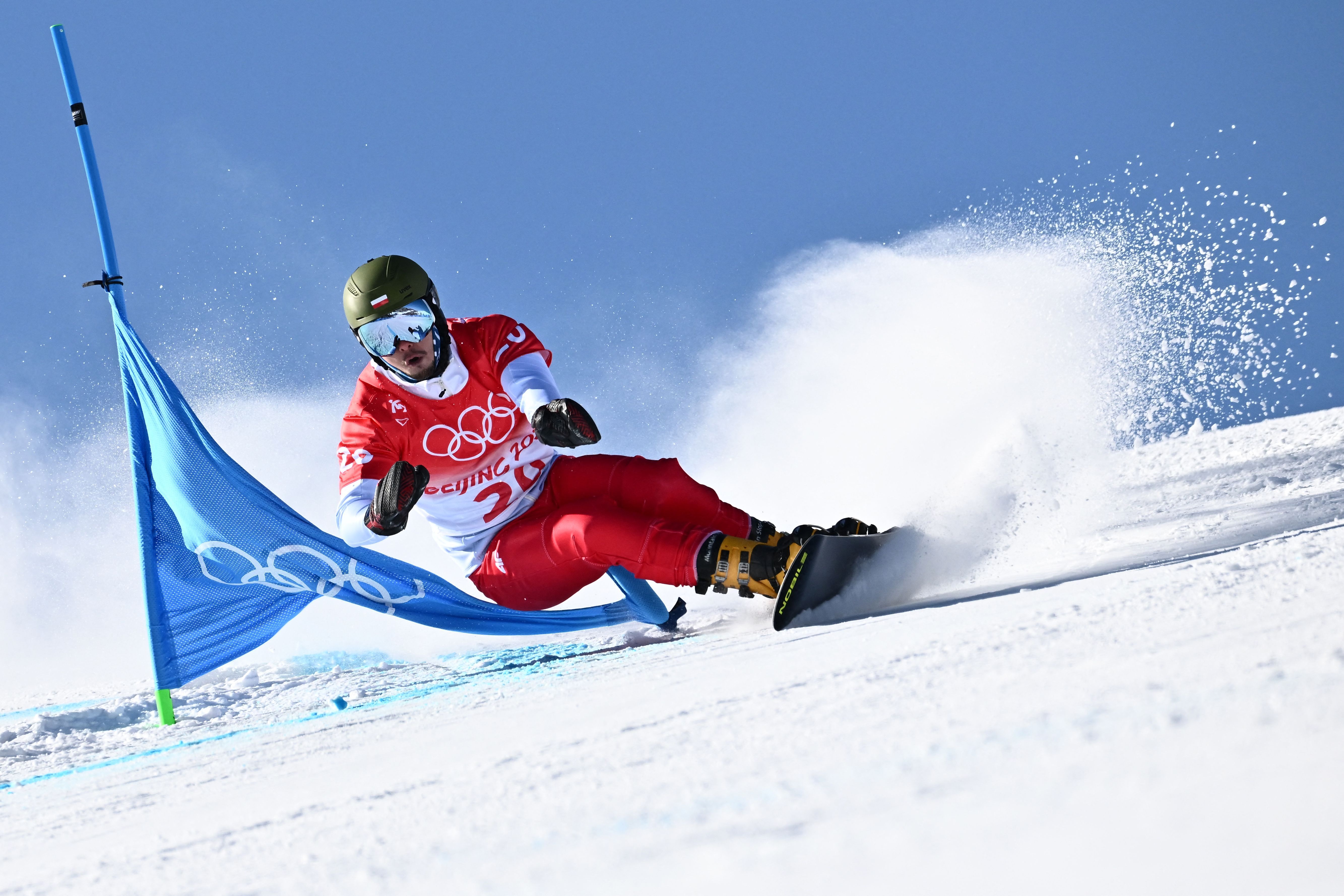 Poland's Oskar Kwiatkowski competes in the snowboard men's parallel giant slalom qualification run during the Beijing 2022 Winter Olympic Games  in Zhangjiakou on February 8