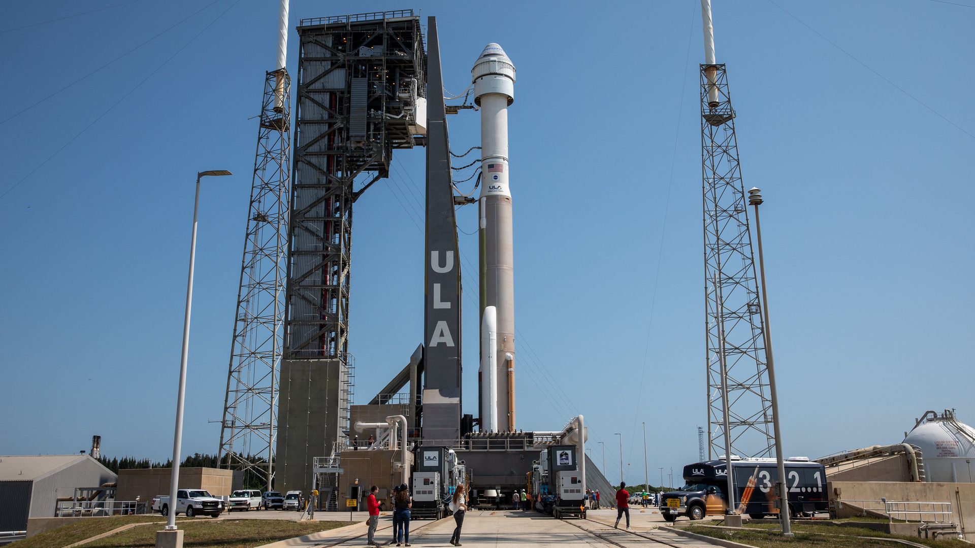 A rocket standing on a launch pad against a blue sky