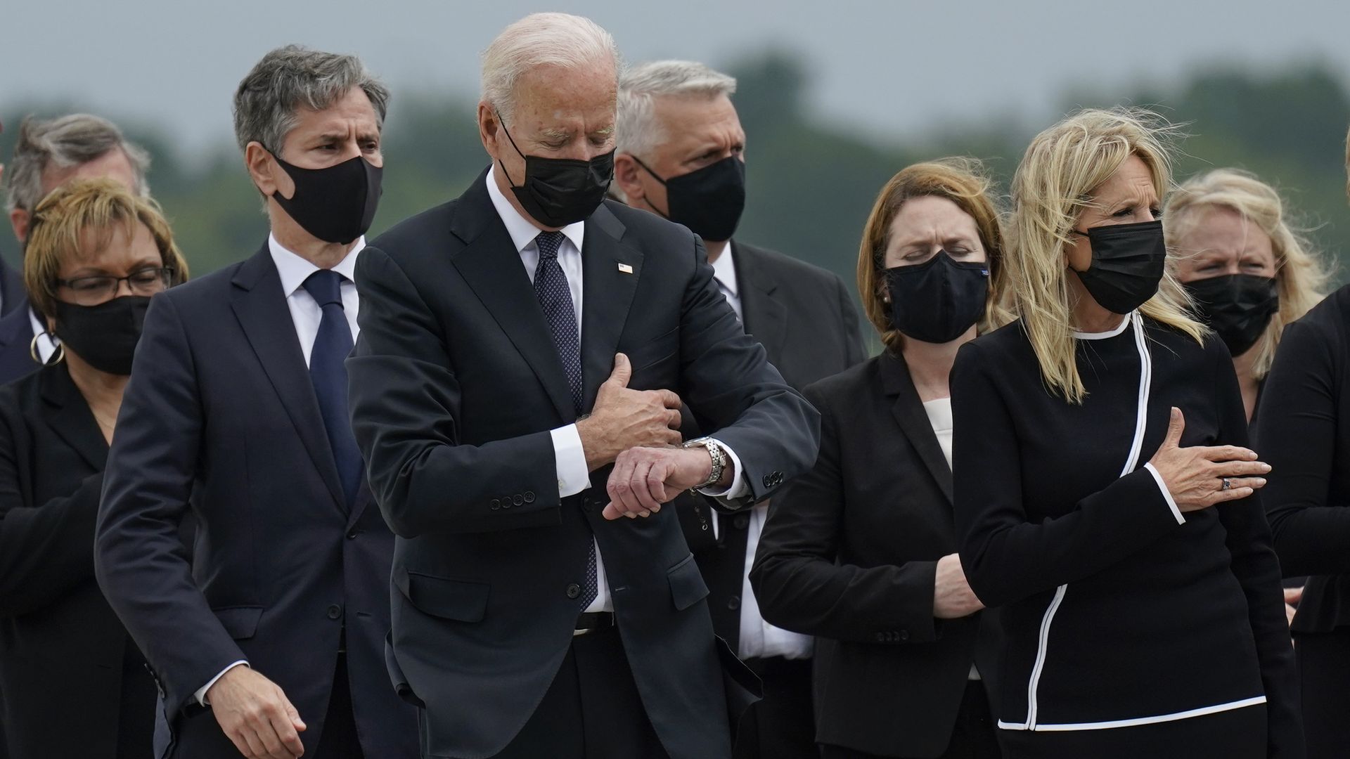 President Biden looks at his watch in a photo taken at 11:51am on Aug. 29, 2021, during a ceremony for soldiers killed in an explosion during the Afghanistan withdrawal.