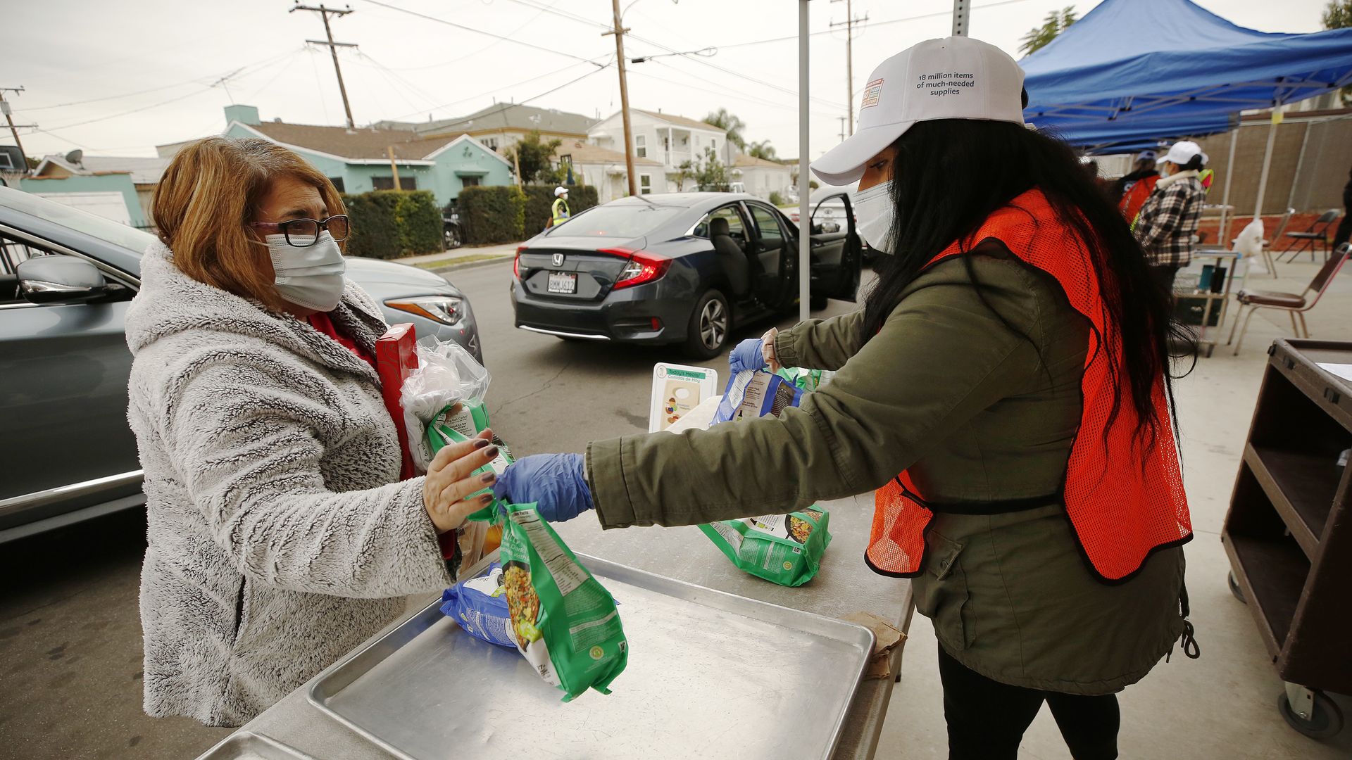A person picking up a meal at Garfield High School in Los Angeles in February 2021.