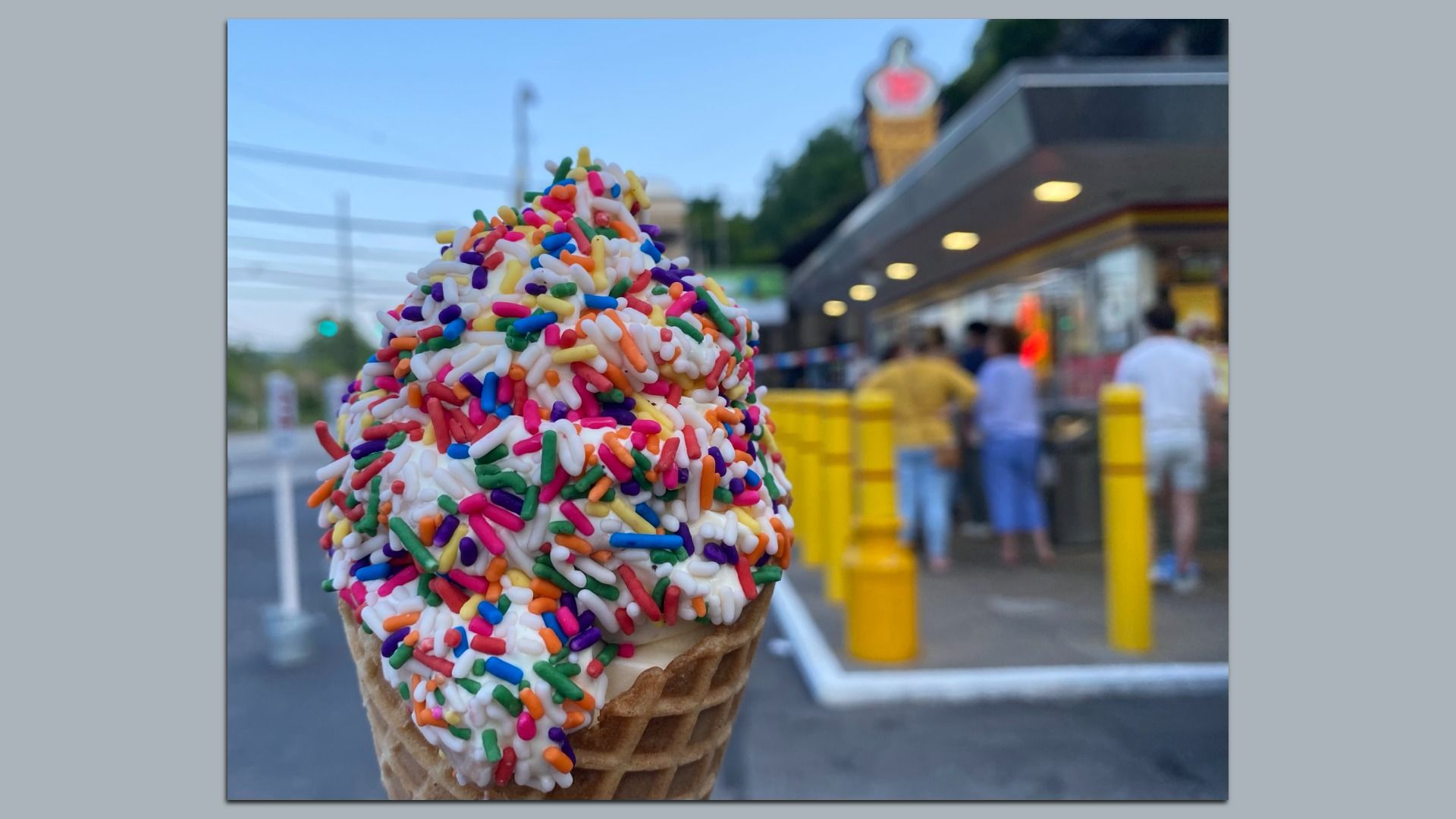 An ice cream cone with rainbow sprinkles.