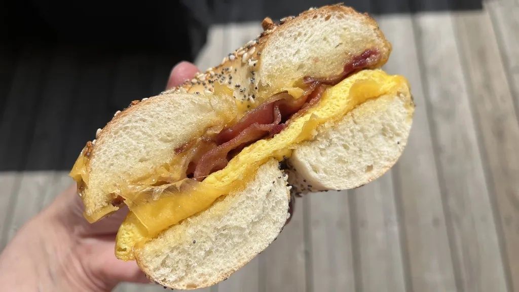A bagel breakfast sandwich cut in half.