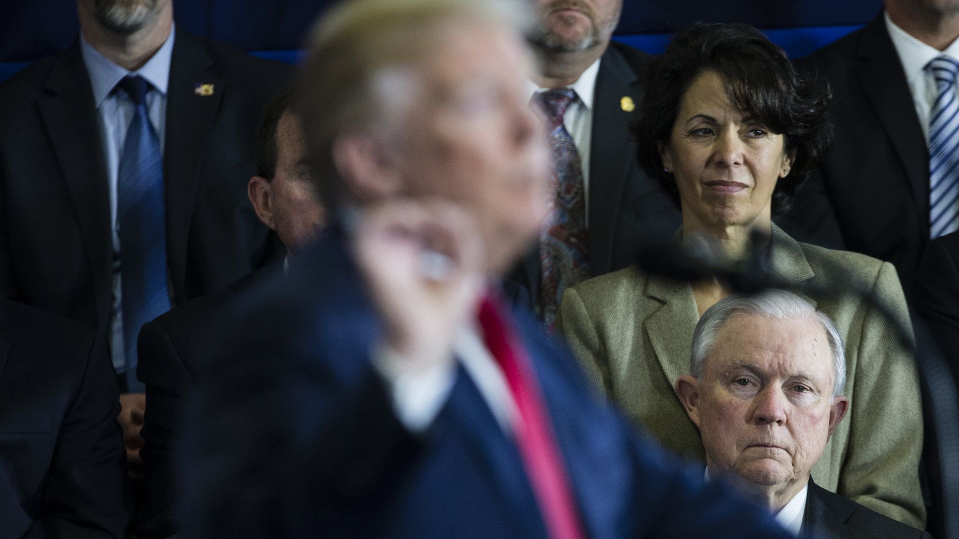 President Trump in the foreground and former Attorney General Jeff Sessions in the background